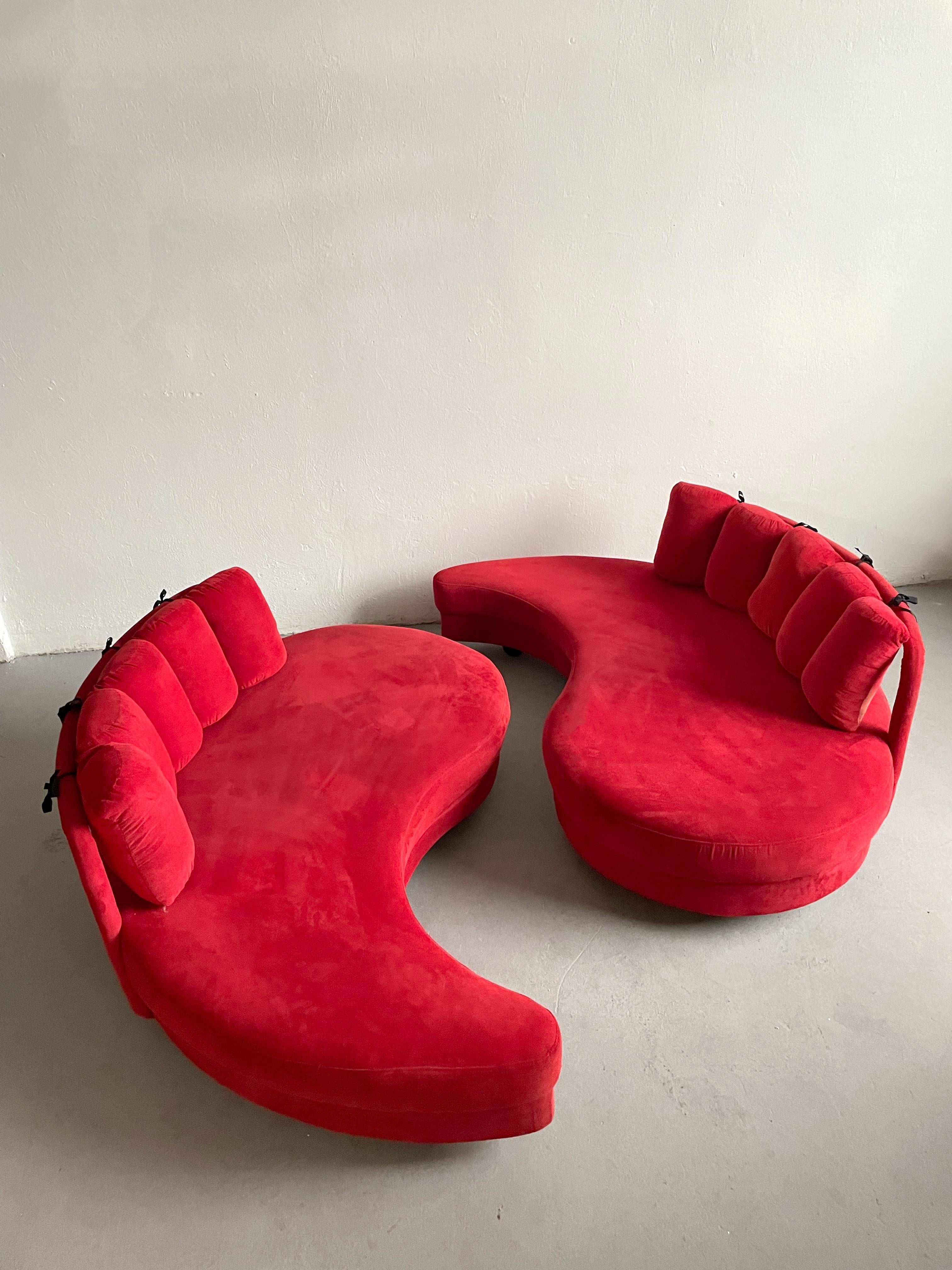  1980s curved sofa daybed 

Price is for the set of 2

Wooden frame upholstered in red fabric supported with five black painted globe-shaped wooden feet 

Unknown manufacturer

Both sofas are in good vintage condition showing some small traces of