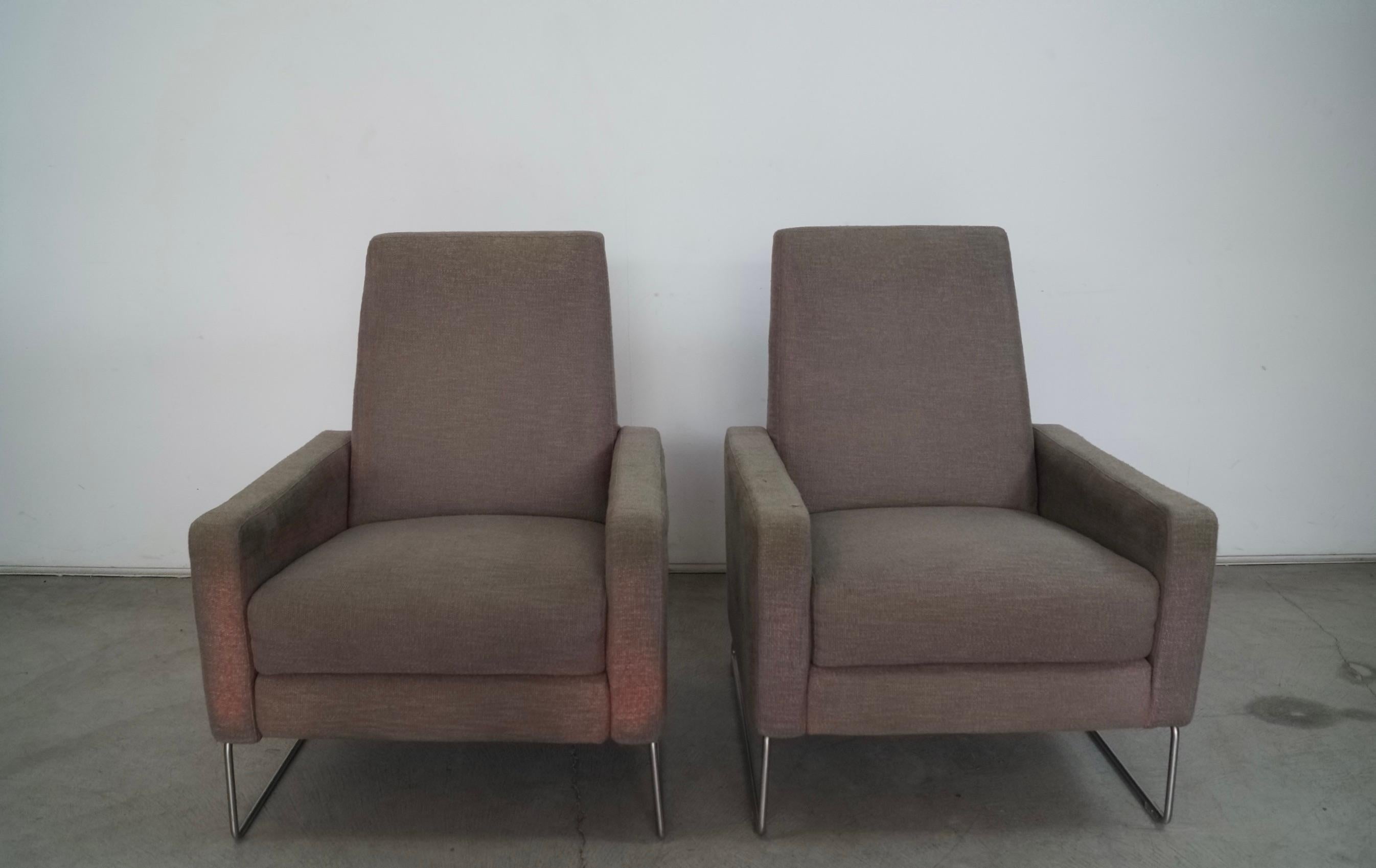 Pair of post modern recliner lounge chairs for sale. Designed in 2005 by Jeffrey Bennett and Nicholas Dodziuk for Designed Within Reach. These were manufactured in 2013, and have the fabric faded and worn. These are the stainless steel base version,