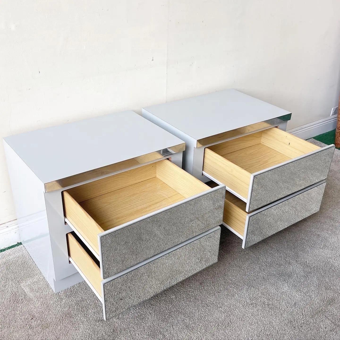 Exceptional postmodern pair of nightstands. Each feature a gray lacquer laminate and two spacious drawers with mirrored faces.

Additional information:
Materials: Mirror, Wood
Color: Gray
Style: Postmodern
Time Period: 1980s
Place of Origin: