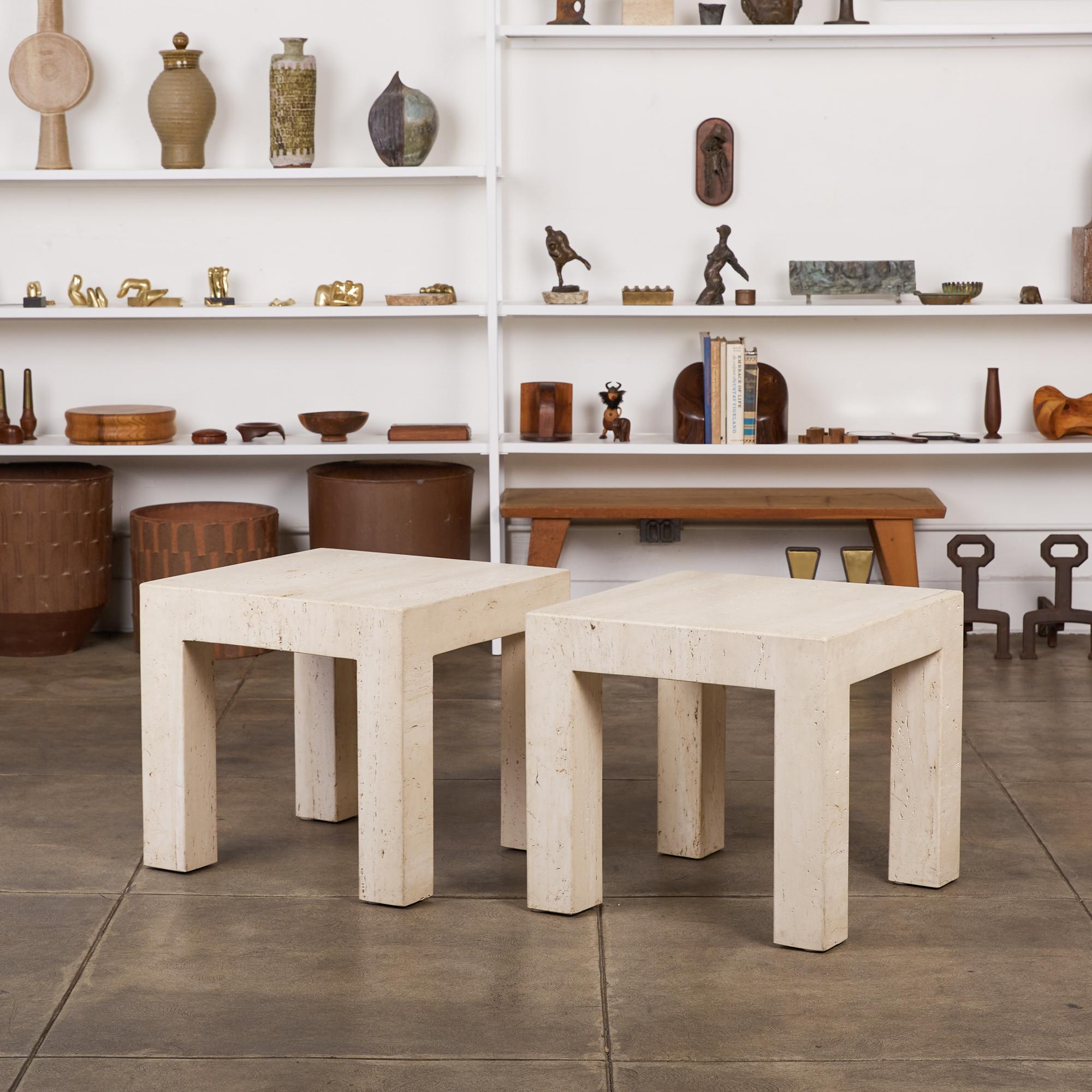 Pair of Postmodern travertine side tables, Italy, c.1970s. These square tables have thick travertine tops, that sit atop four square column legs. With a sleek shape that is reminiscent of tables designed by Italian legends Mario Bellini and Angelo