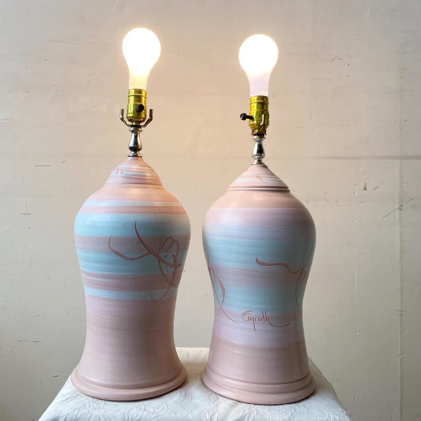 Incredible pair of postmodern sculpted pottery table lamps. Features a pink and blue finish.

Additional Information:
Material: Pottery
Color: Pink
Style: Postmodern
Time Period: 1980s
Dimension: 8ʺ W × 8ʺ D × 19.5ʺ L