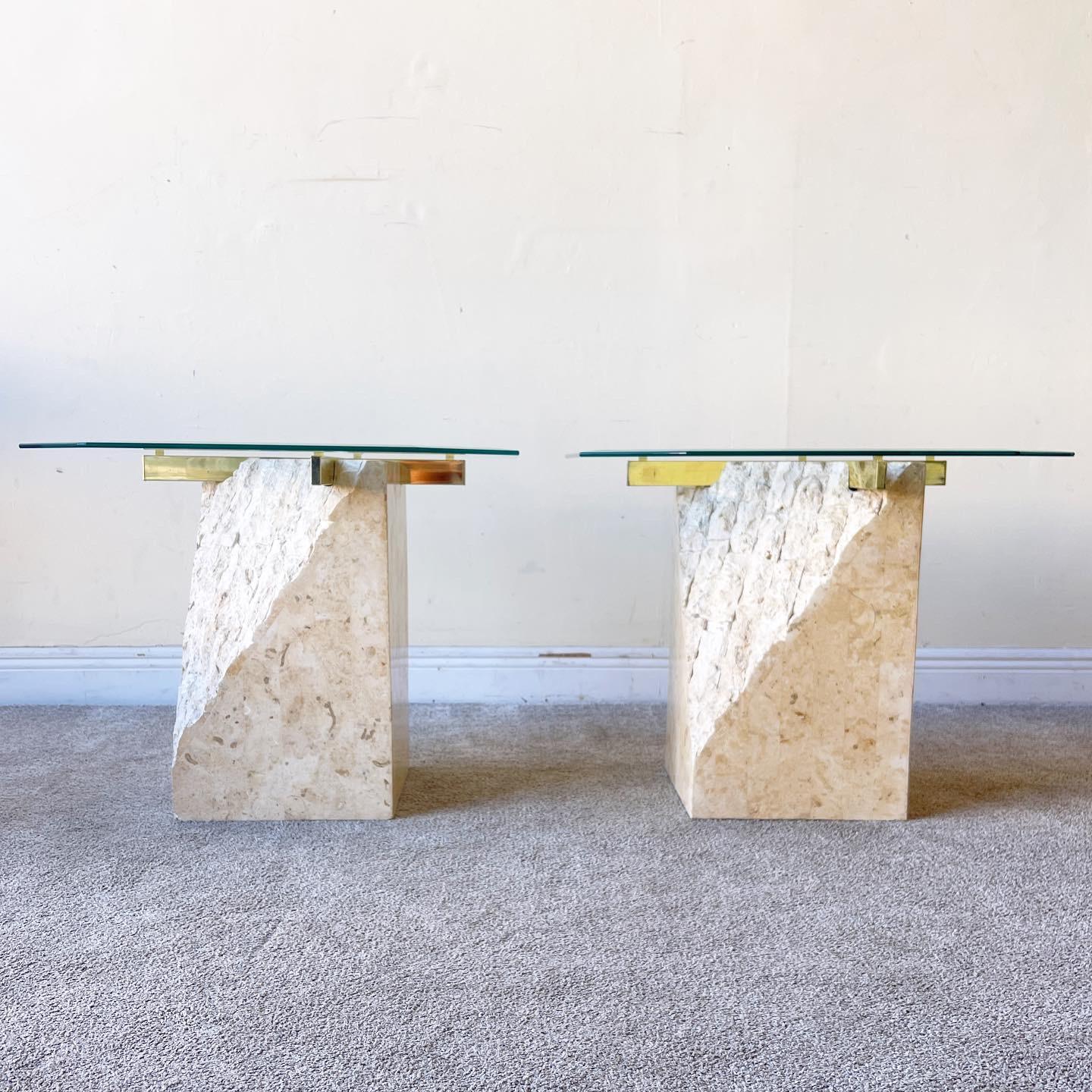 Incredible pair of tessellated stone side tables. Features a triangular slope of rough stone with the rest of the table displaying a polished stone. A brass finished cross bar at the top holds up the octagonal, beveled glass top.

Additional