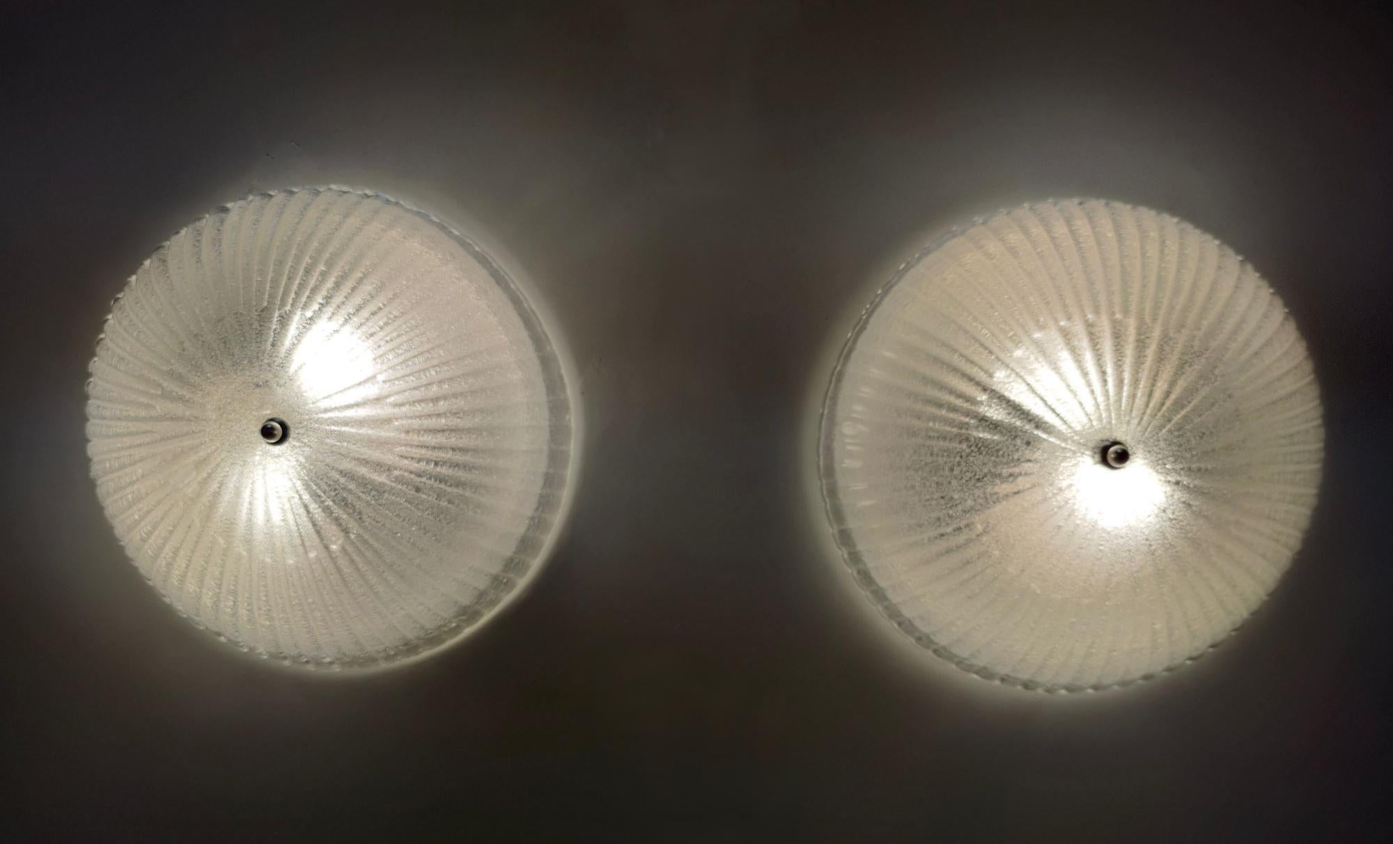 Made in Italy, 1970s. 
Made in Murano glass and metal.
They are vintage, therefore they might show slight trace of use, but they can be considered as in excellent original condition and ready to give ambiance to any room.
The glass lampshades are in