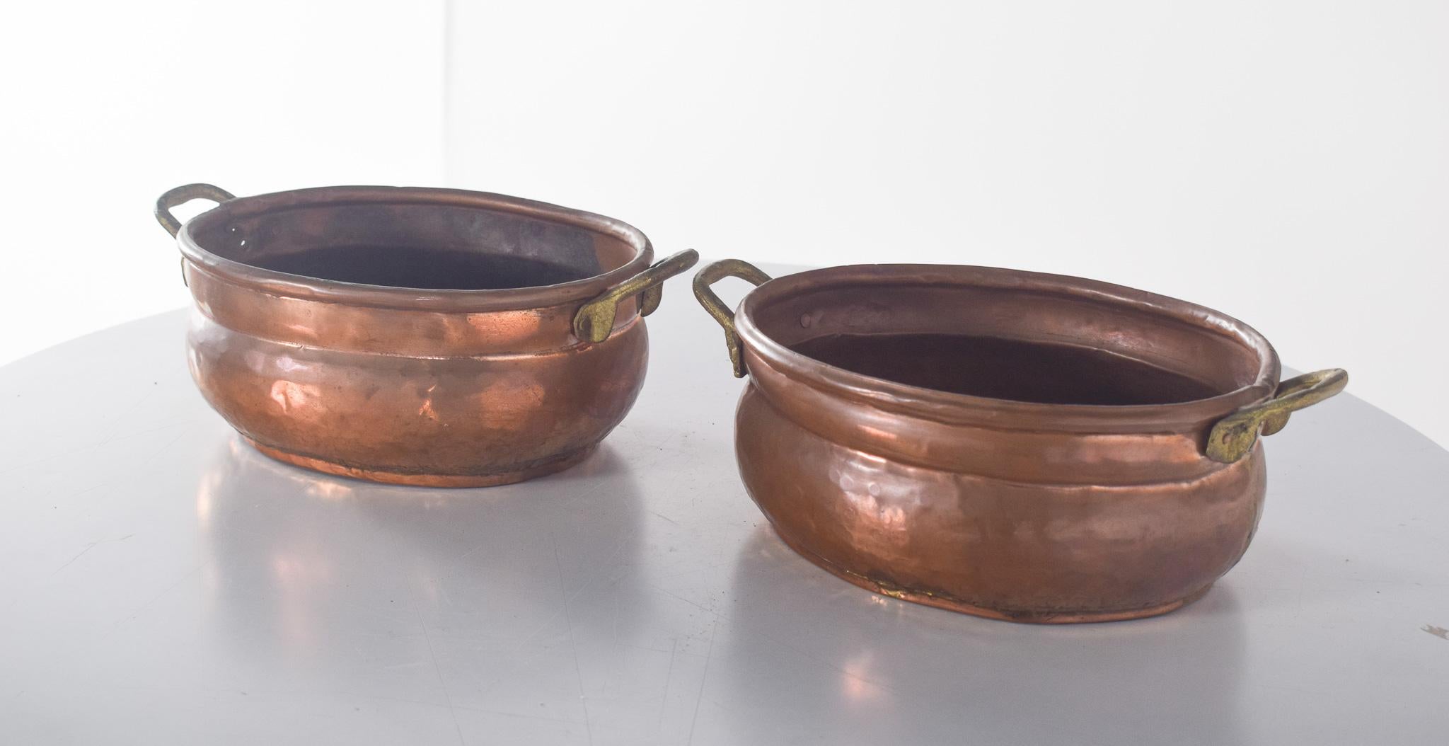 Pair of Pots with two handles, in copper. Old, with a rounded and slightly curved shape, it has a rustic and traditional look. Made from high-quality copper, it features a hand-hammered finish, which highlights its authenticity and artisanal