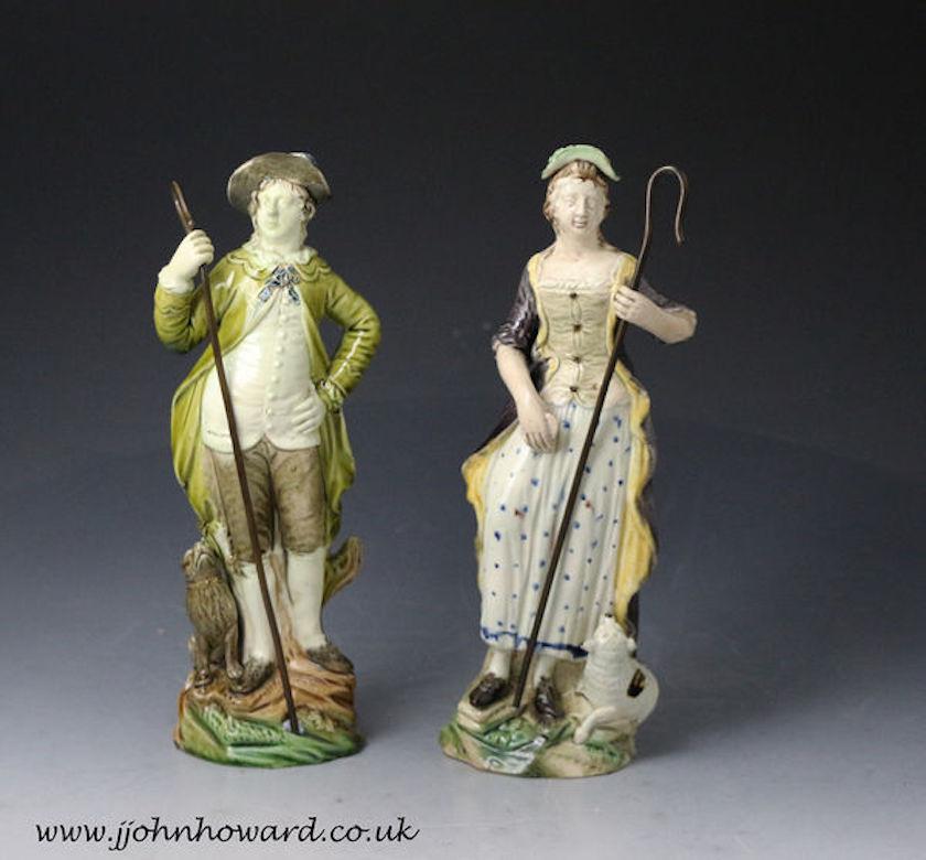 Pair of pottery figures of a Shepherd and Shepherdess made by the Ralph Wood Pottery late 18th century.

Pair of pottery figures of a shepherd and shepherdess with dog and lamb at their feet modeled on a rocky base. The male character wears a