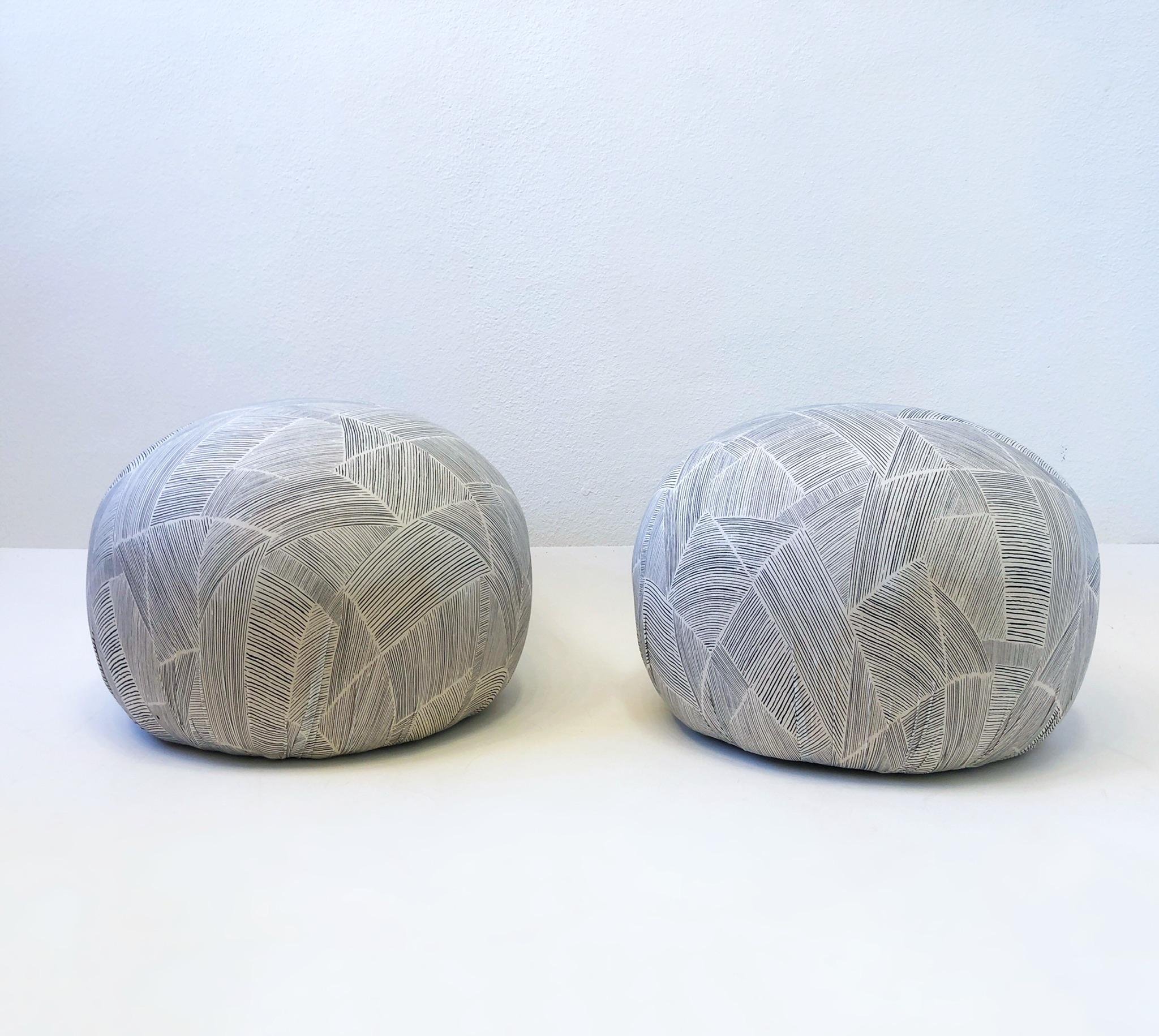 Pair of 1980’s ottoman poufs designed by Directional. 
Newly recovered in a jersey fabric.
Measurements: 24” Diameter, 18” High.
 