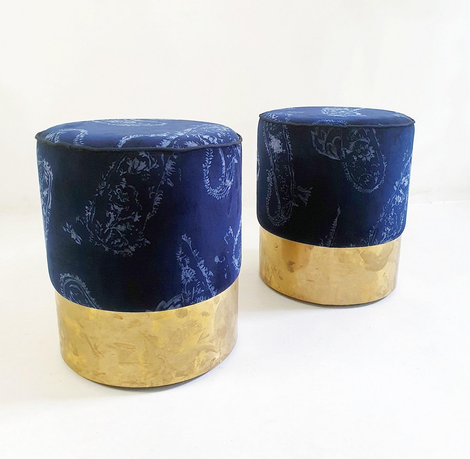 These particular poufs are handmade in Italy and upholstered with a paisley printed blue velvet and have a finishing rim in brass. There is a superb quality and stability due to the underlying wood structure and they stand firmly on the ground. The