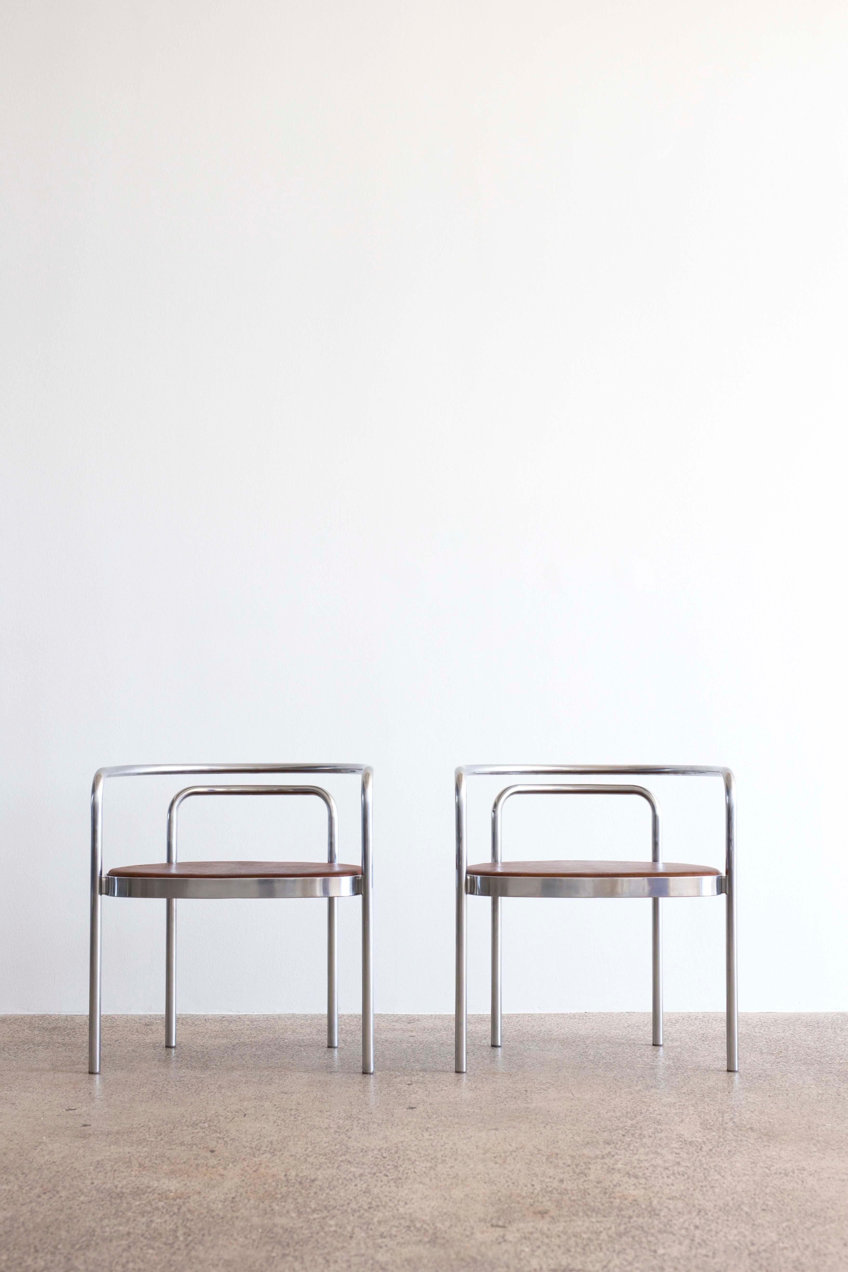 Ein Paar PK-12-Stühle von Poul Kjaerholm für E. Kold Christensen. 

Gestell aus verchromtem Stahl und Sitz mit braunem nigerianischem Leder gepolstert. 

Entworfen 1964, hergestellt bei E. Kold Christensen, Dänemark, mit