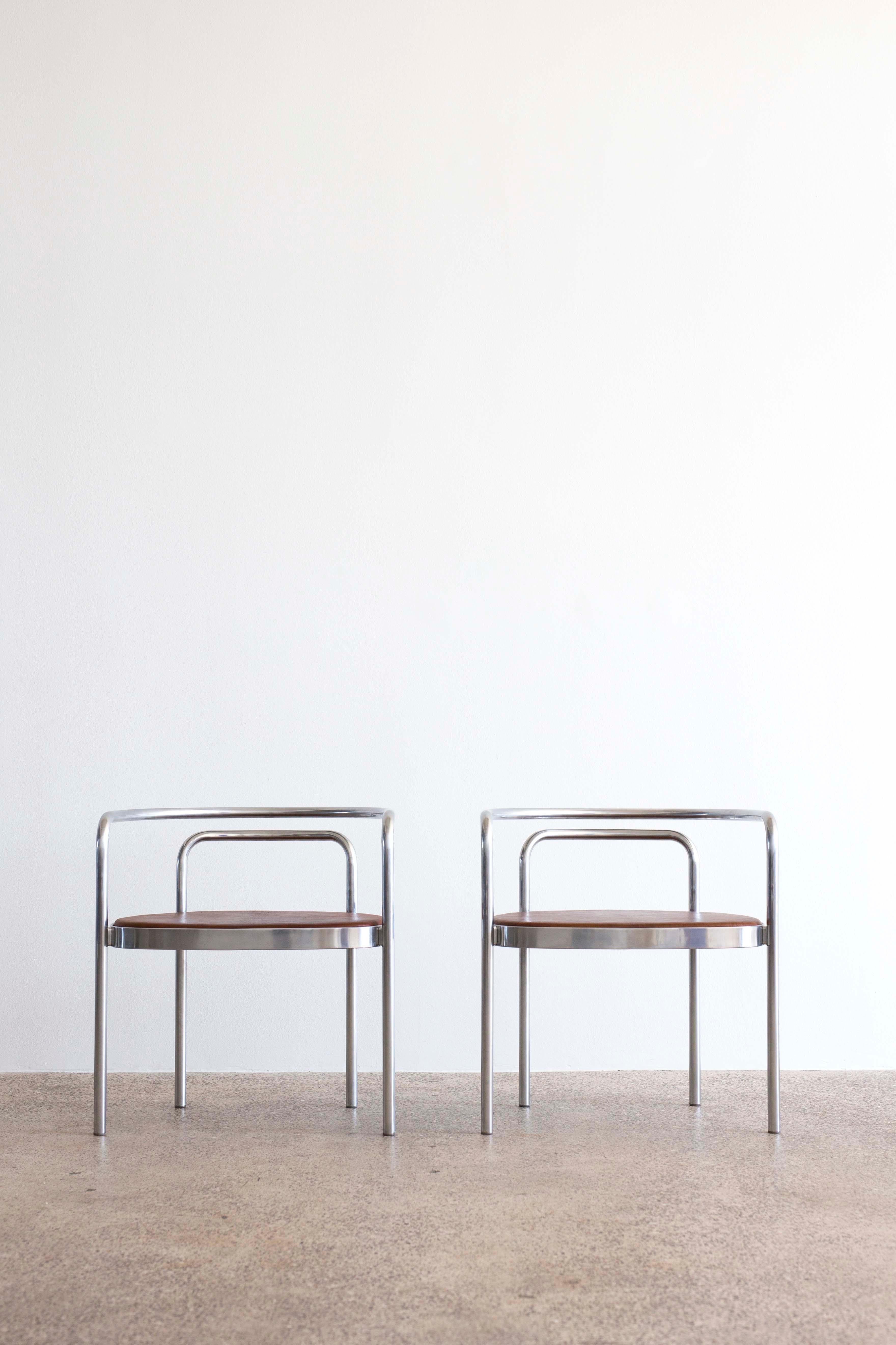 A pair of Poul Kjaerholm PK-12 chairs for E. Kold Christensen. 

Chromed steel frame and seat upholstered with brown Nigerian leather. 

Designed 1964, made at E. Kold Christensen, Denmark with manufacture's mark.
    