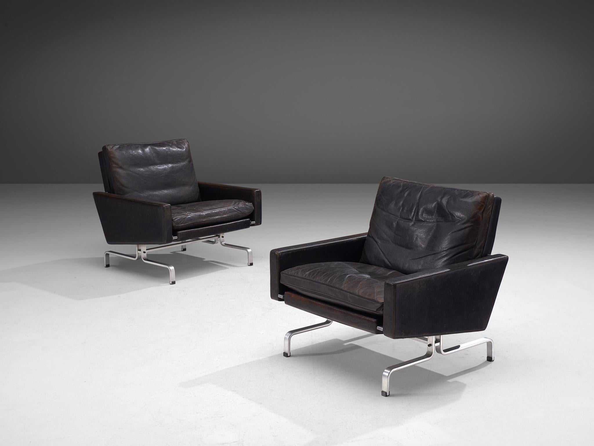 Poul Kjaerholm for E. Kold Christensen, pair of PK 31 lounge chairs, leather and metal, Denmark, 1958.

Beautiful pair of PK31 Lounge chairs in aged black leather by Poul Kjaerholm for E. Kold Christensen. This set of chairs features Poul