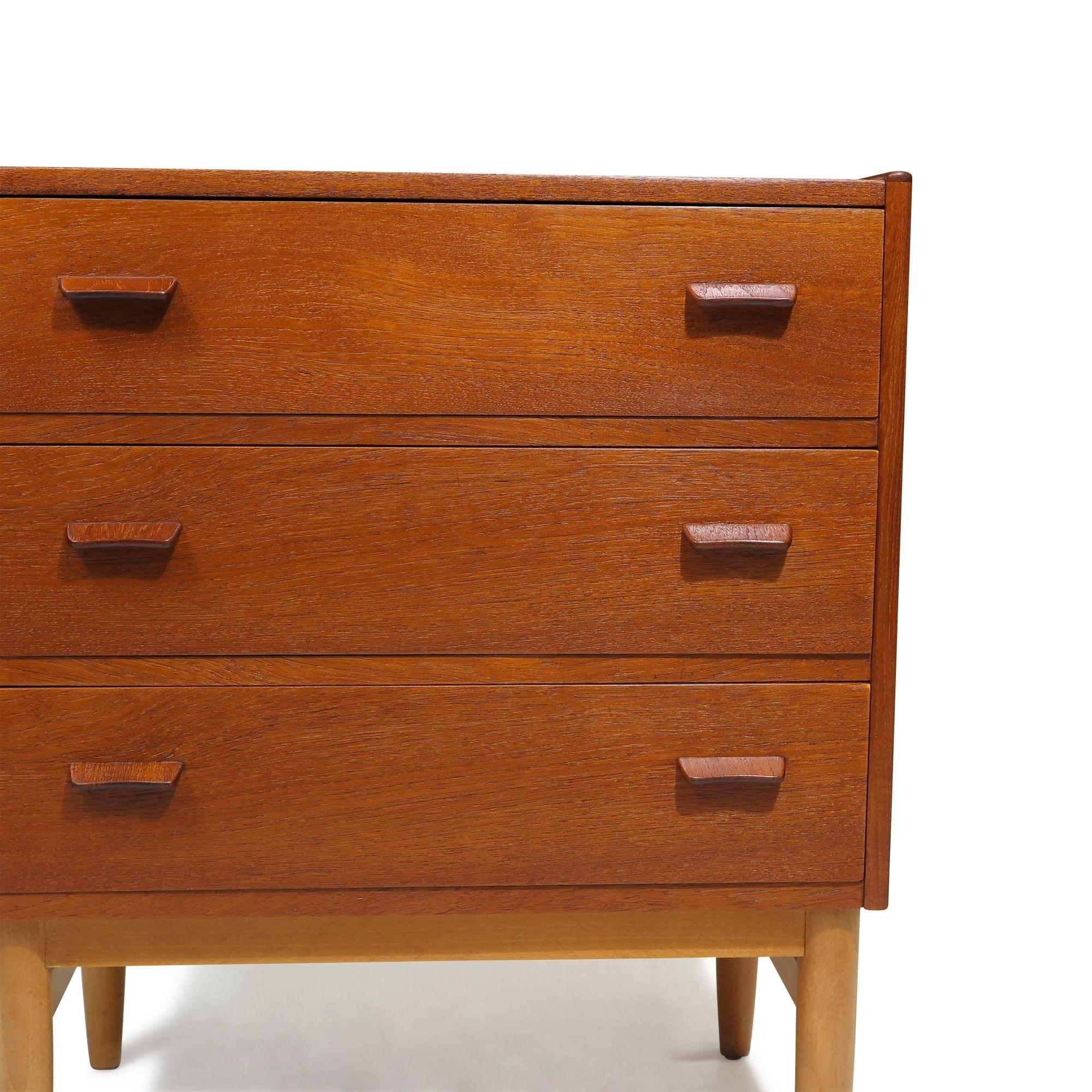 Pair of Mid-century Danish teak nightstand cabinets designed by Poul M. Volther for FDB Møbelfabrik, 1958, Denmark. Crafted from teak, each cabinet features three drawers with carved pulls and is raised on solid beech legs. Each stamped with model