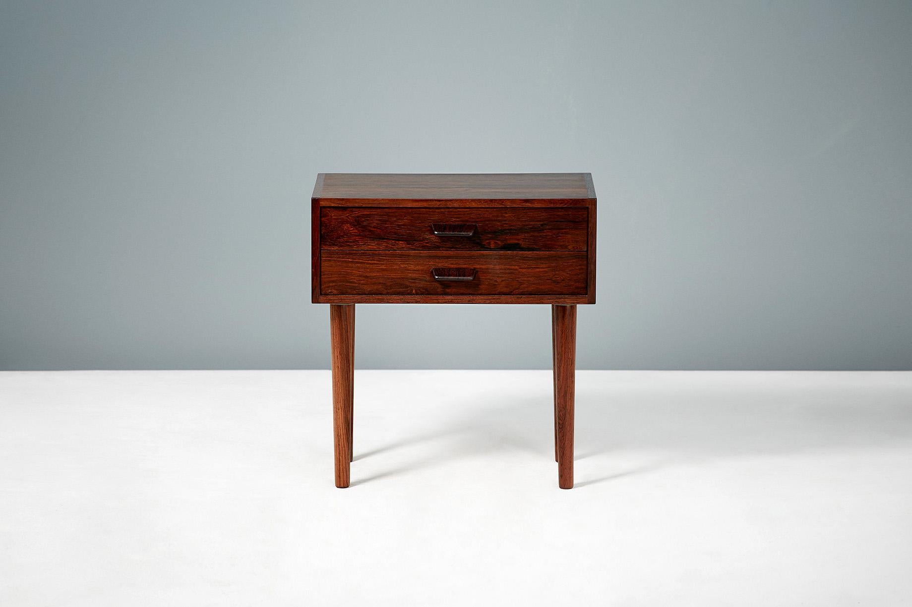 Pair of 1960s vintage rosewood bedside cabinets. Design attributed to Poul Volther & produced in Denmark. Each cabinet has 2 drawers with slanted drawer pulls and turned, tapered legs.