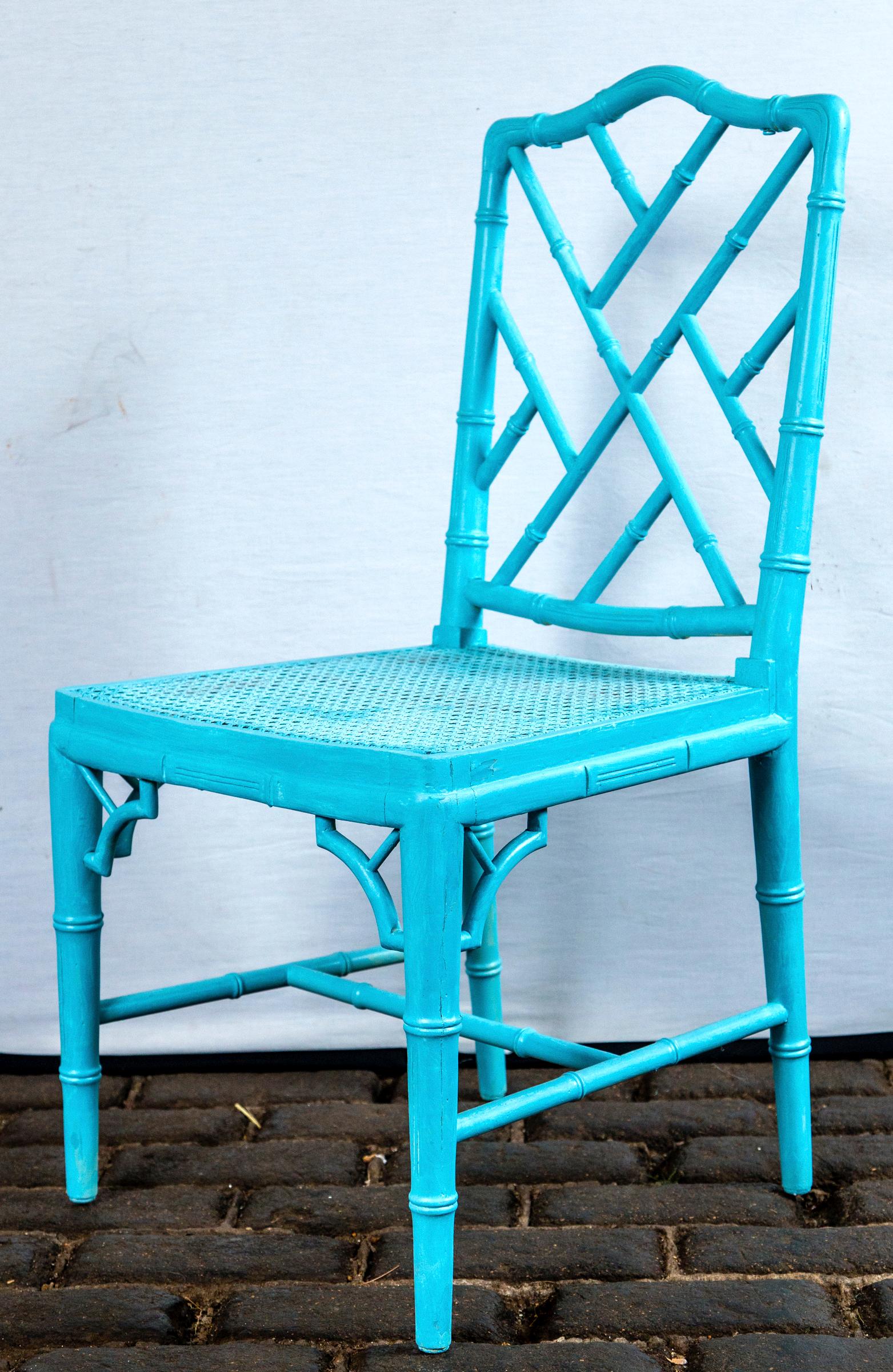 Pair of powder blue armless Chinese Chippendale chairs, carved wood, caned seats. Measures: Seat depth 16.75 inches.