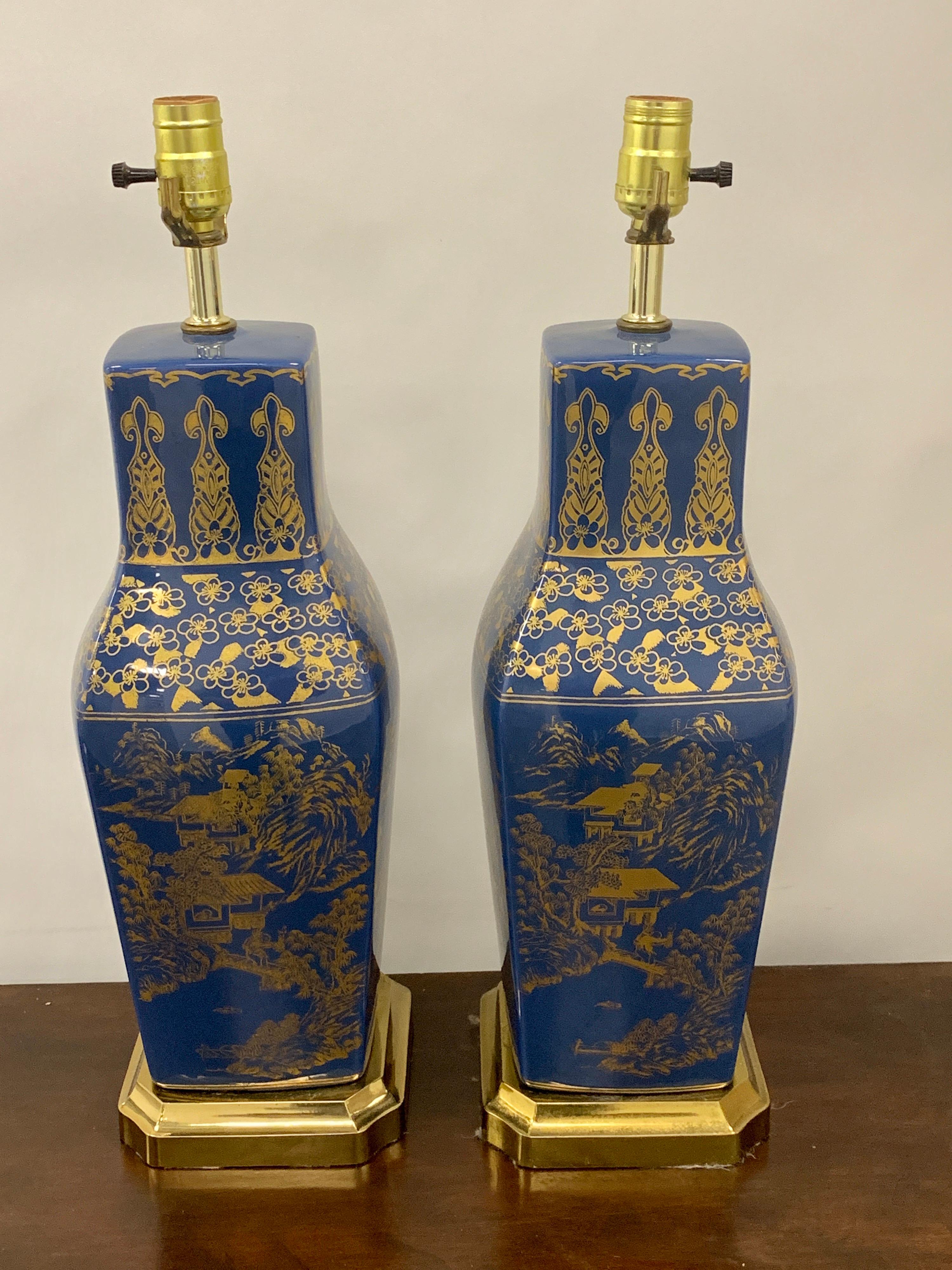 Pair of powder blue Chinese export porcelain with gilt decoration, each one raised on stepped brass base, with fine gilt chinoiserie decoration. New wiring.
Each lamp is raised on a 6.5