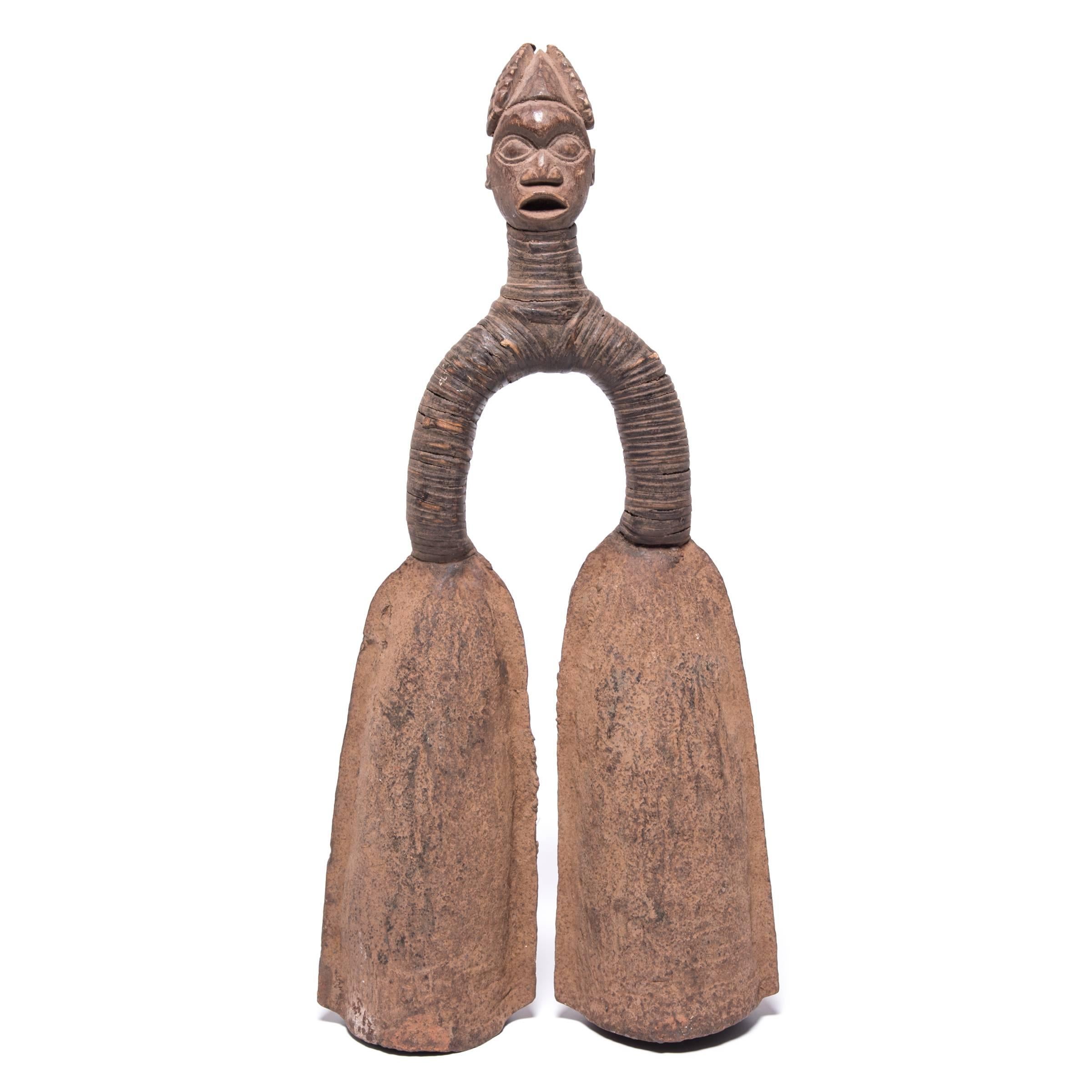 Like many pieces of traditional African metalwork, this pair of sculptural double bells served multiple purposes for the tribe. They were ceremonial instruments, status symbols, and traded as currency. Using a rubber coated stick, members of the