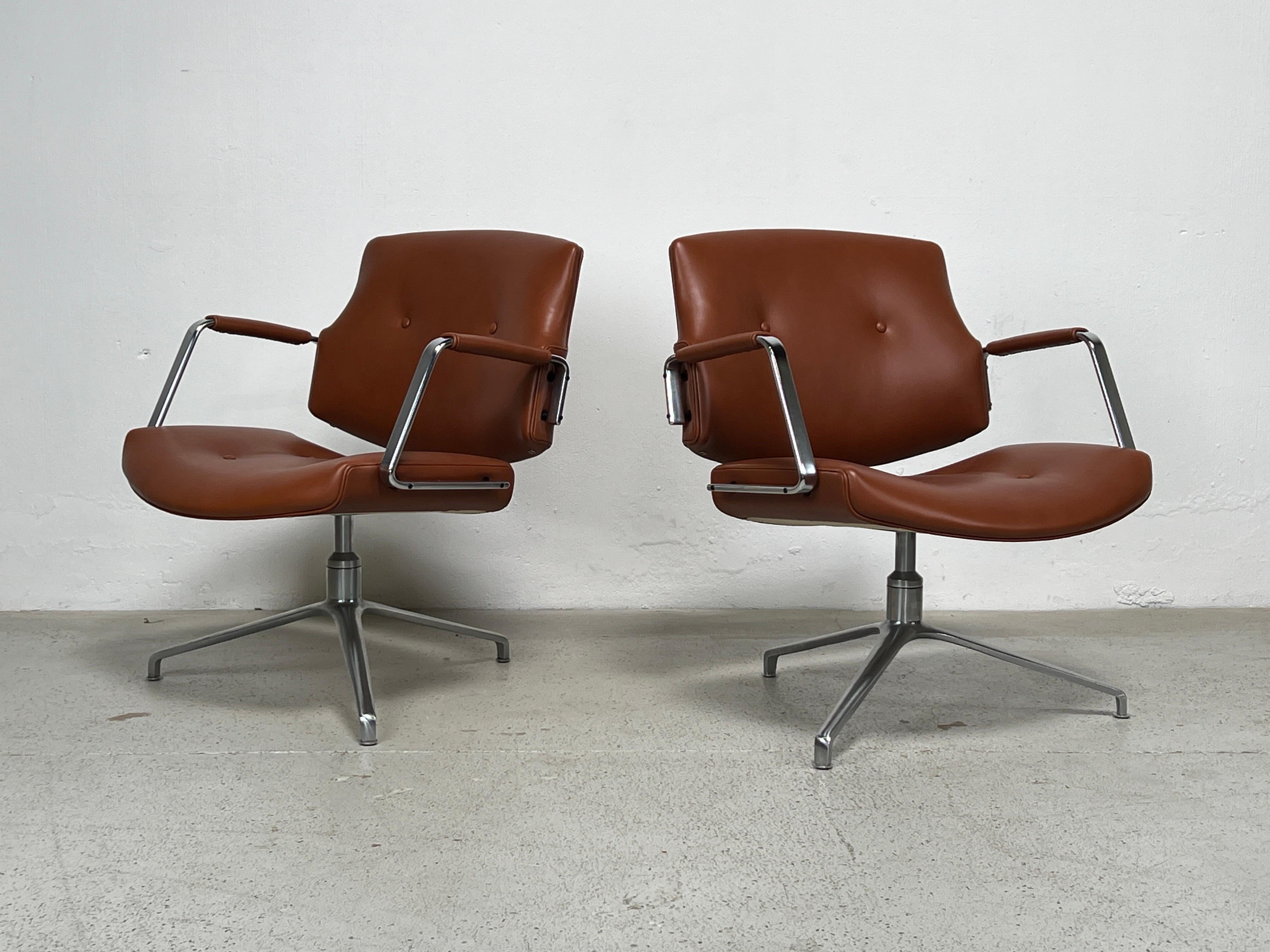 A pair of Model FK84 swivel chairs by Preben Fabricius & Jørgen Kastholm for Kill International, 1962. Early production with cantilevering back rest, in new brown leather on a three star chrome-plated base.