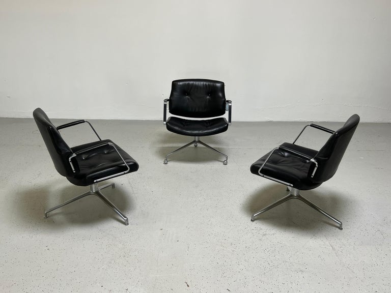 A pair of Model FK84 swivel chairs by Preben Fabricius & Jørgen Kastholm for Kill International, 1962. Early production with cantilevering back rest, in black leather on a three star chrome-plated base. Matching desk chair available.