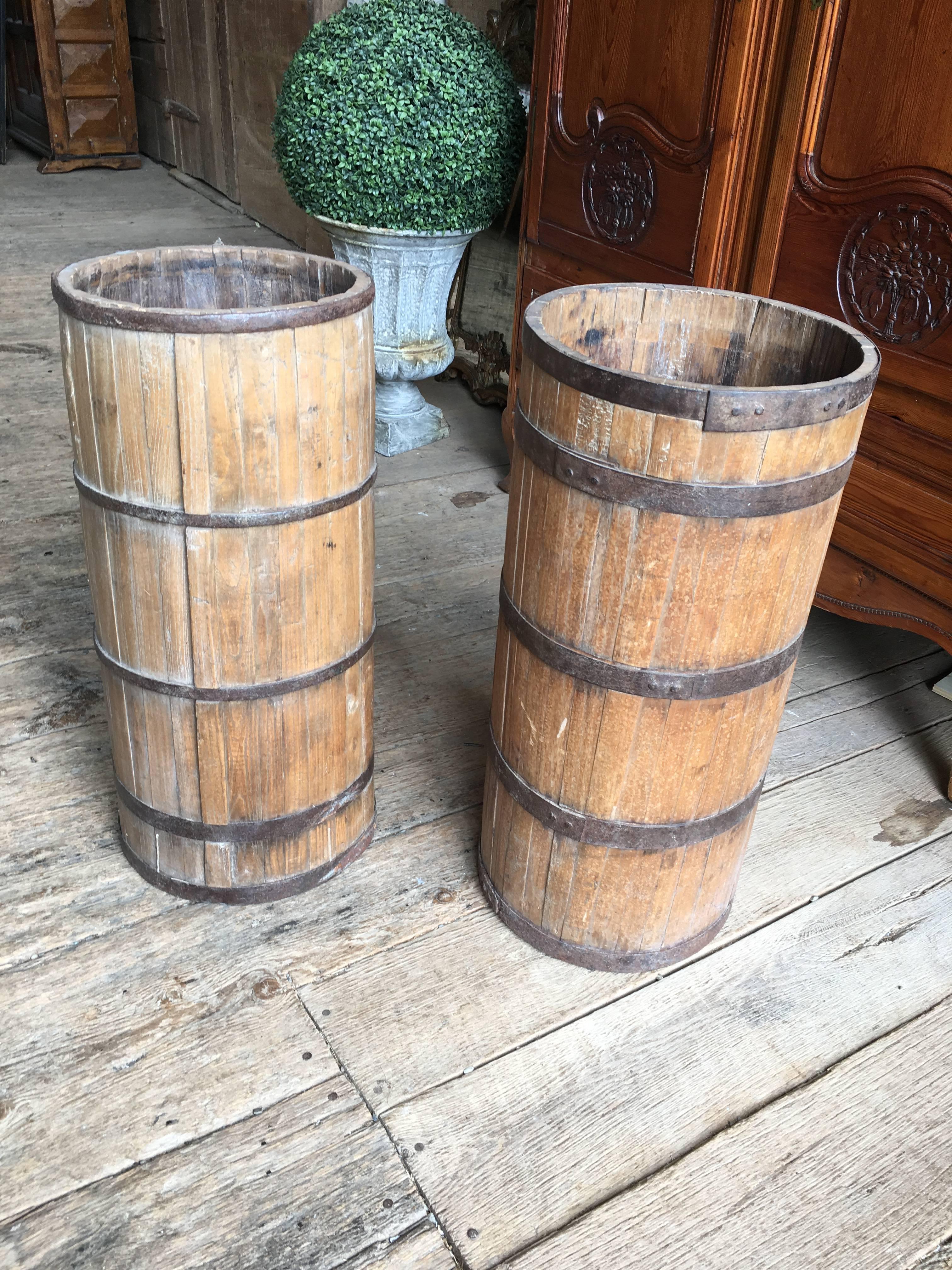 A pair of primitive tall and narrow wood and iron barrels, possibly Chinese, circa 1850.