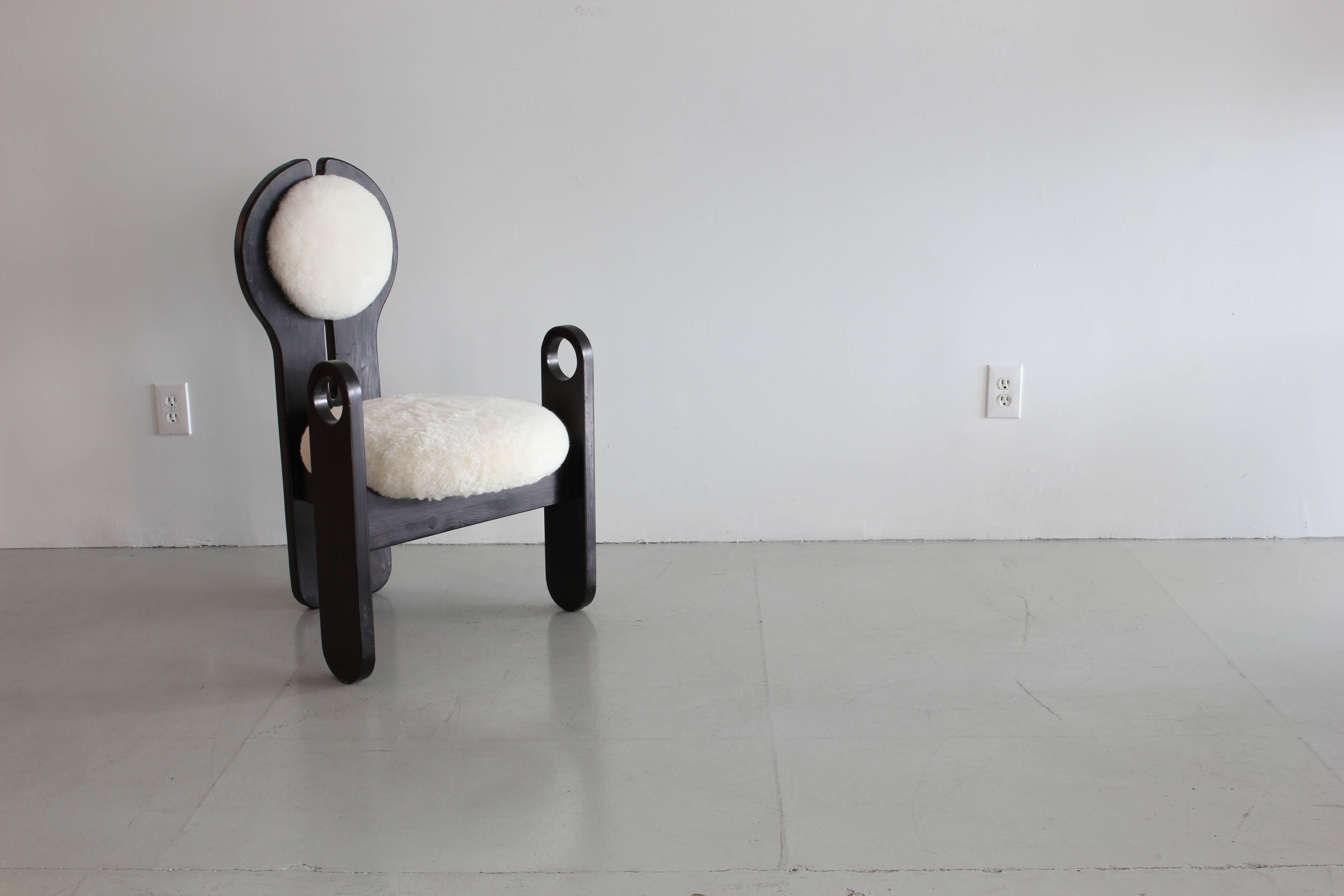 Incredible one-of-a-kind pair of chairs in ebonized pine and sheepskin upholstery. Sold as a pair.
Also sold individually.