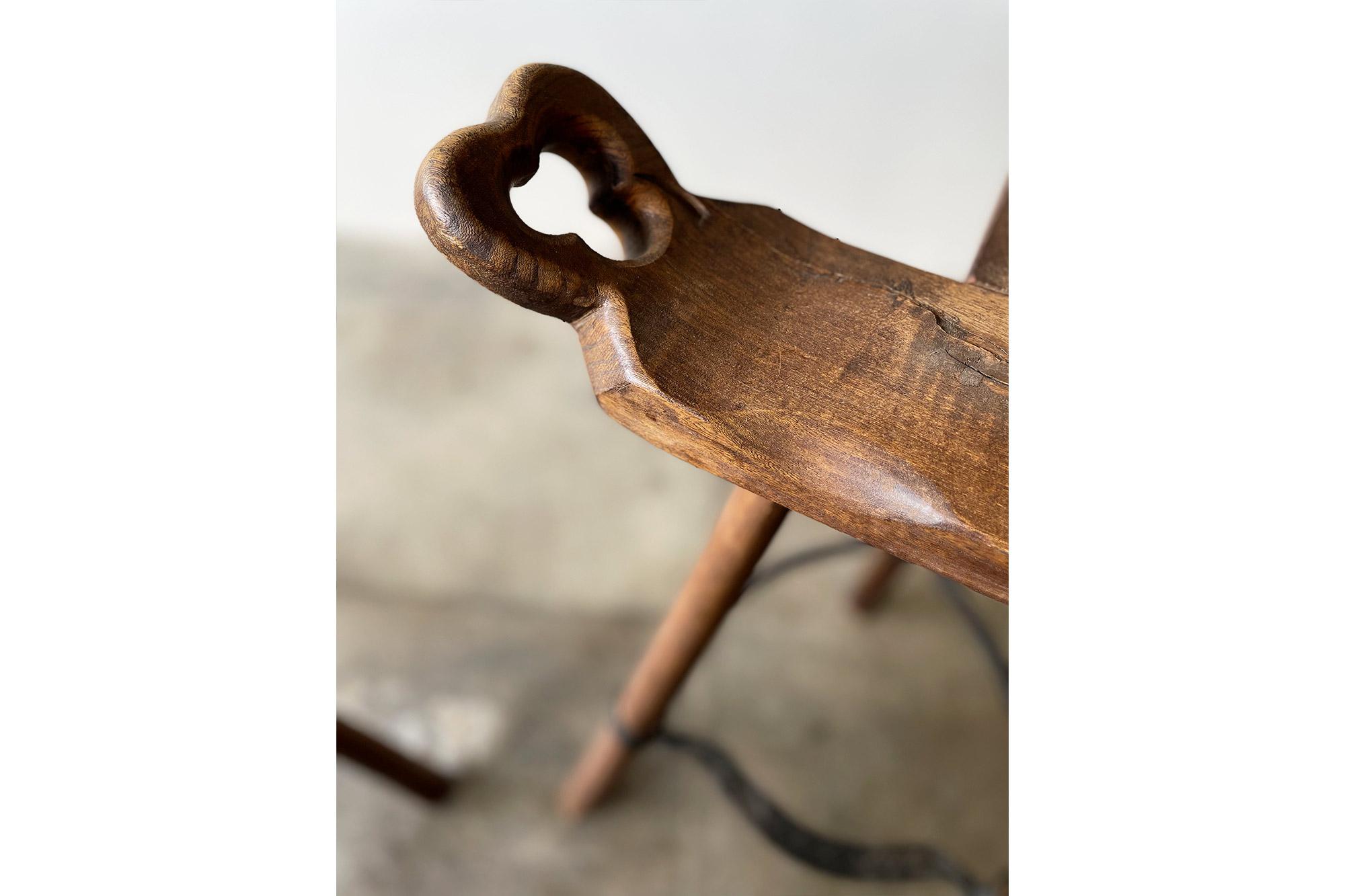 Steel Pair of Primitive Carved Wood “Birthing” Bar Stools For Sale