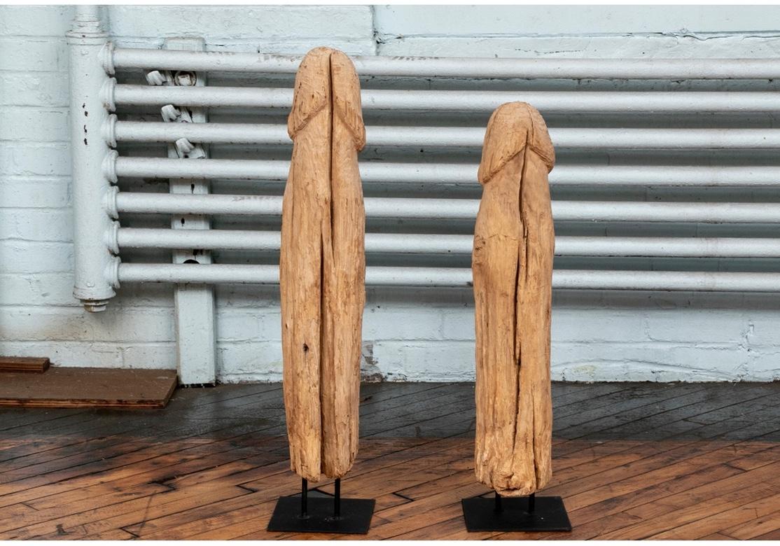 A pair of powerful carvings believed to be Indonesian fertility sculptures, possibly part of a shrine. They are realistically carved and the time-worn wood presents in a driftwood finish. The carvings bear age borne cracks however have lost none of