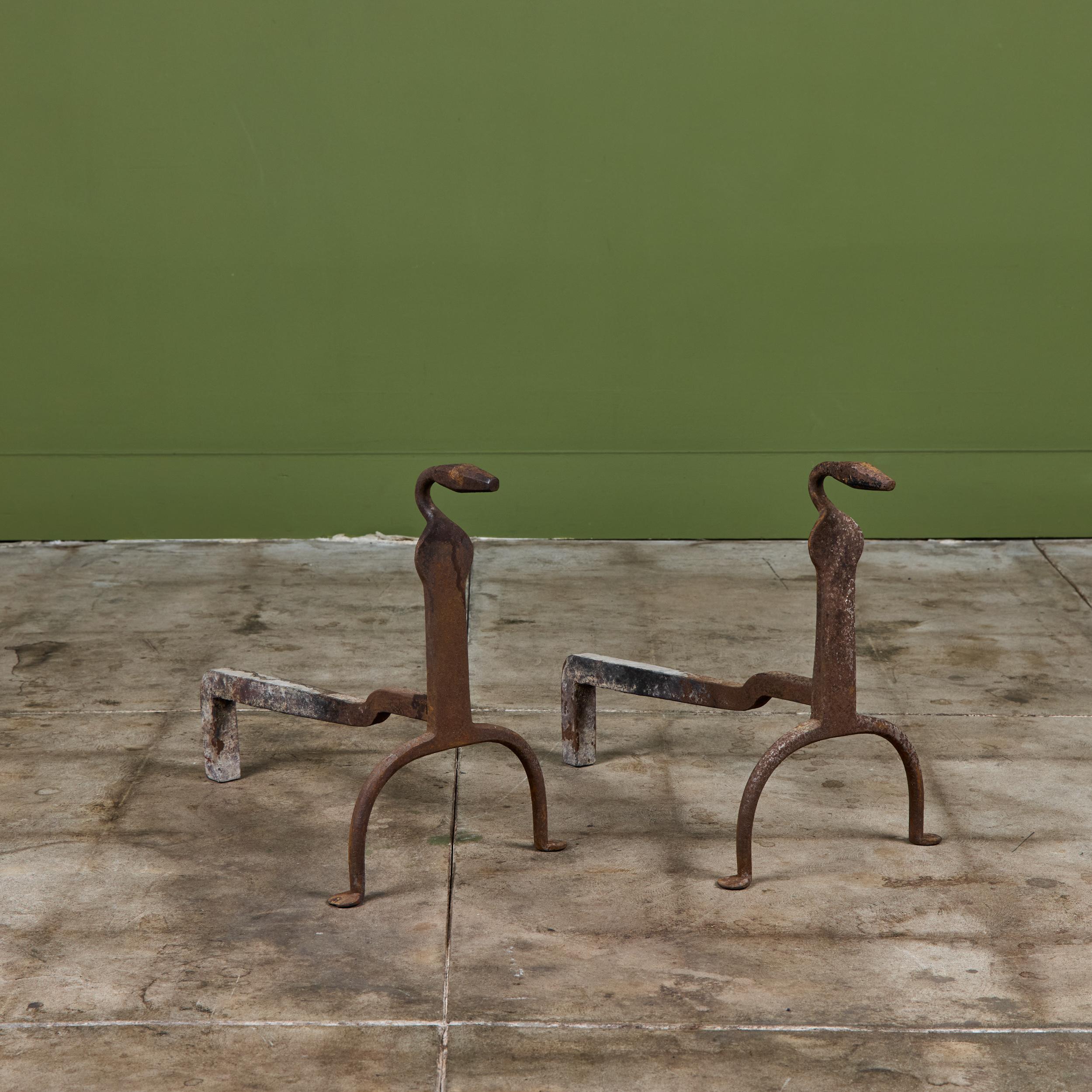 Pair of wrought iron andirons featuring animal-like finials and curved feet.

Dimensions
12