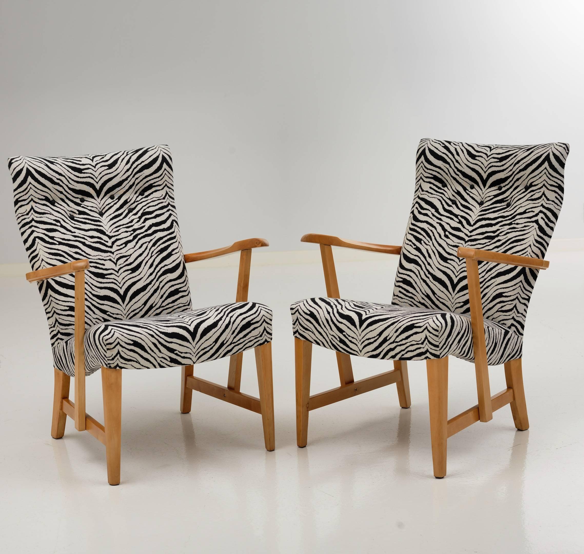 Pair of restored Prinssi easy chairs by Carl-Gustaf Hiort af Ornäs from 1945. Upholstered with high quality wool fabric with zebra pattern. Wooden parts restored. Measures: width 62.5cm, depth 70cm, height 86cm, seat height 43cm. Labelled.