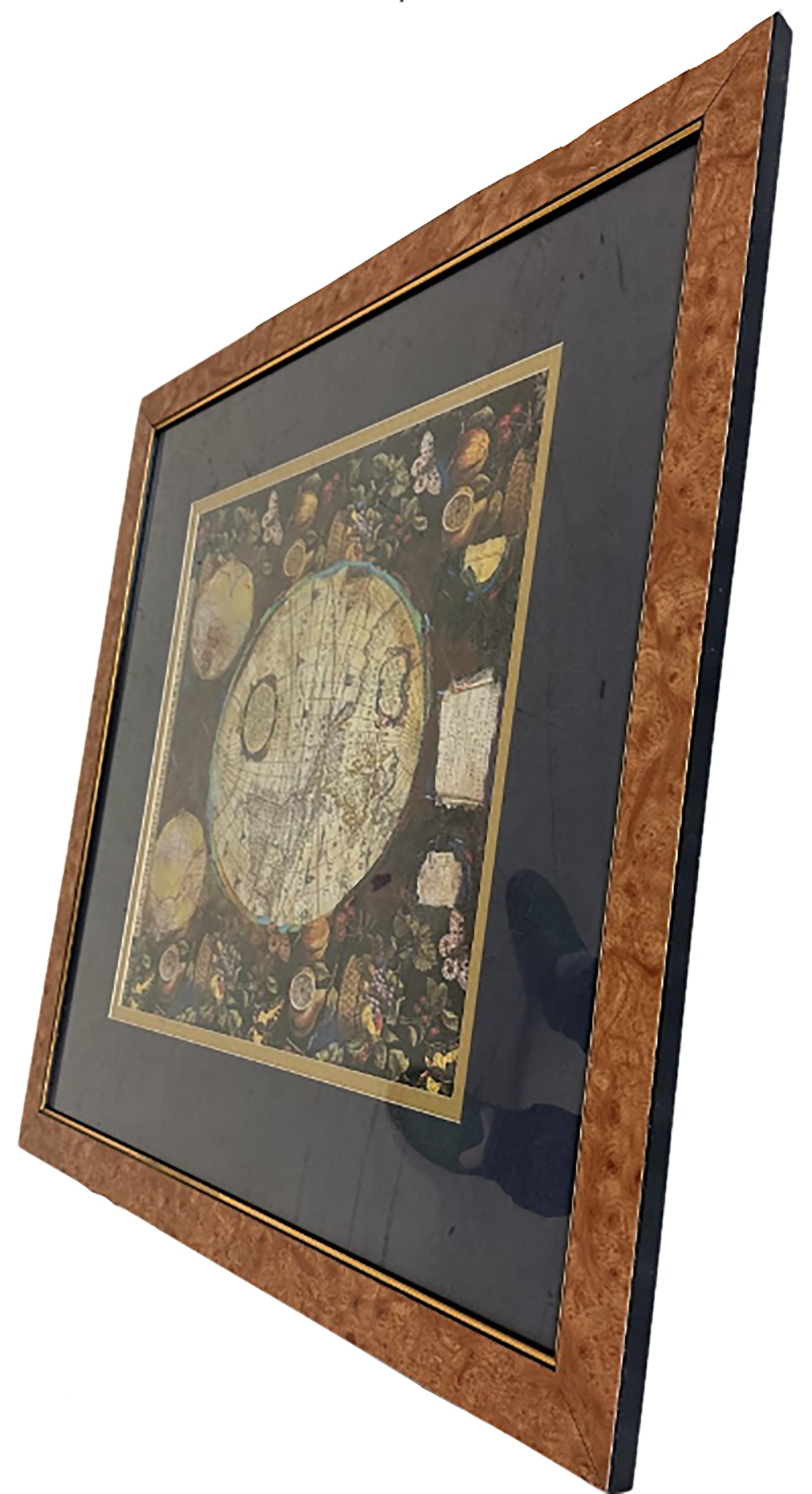 A pair of prints depicting antique world maps framed in burl wood. One picture contains a depiction of Africa, Europe, and Oceania. The other picture is of North and South America. Touches of paint have been used to add some interest and artistic