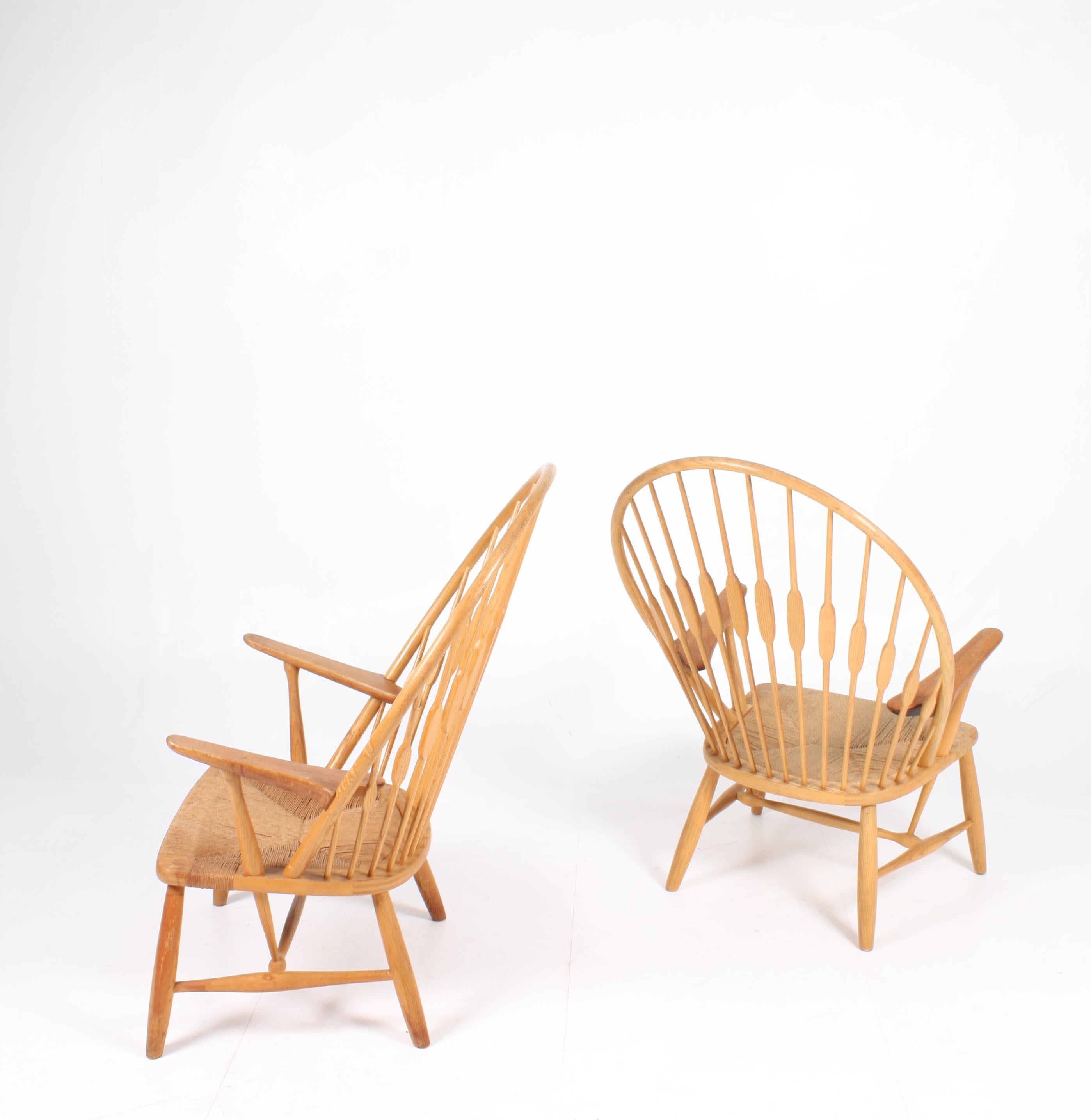 Pair of old peacock chairs by designed by Hans J Wegner for master cabinetmaker Johannes Hansen. The chair shows a very nice patina on both frame and seat. Made in Denmark in the mid 1960s. Great original condition.