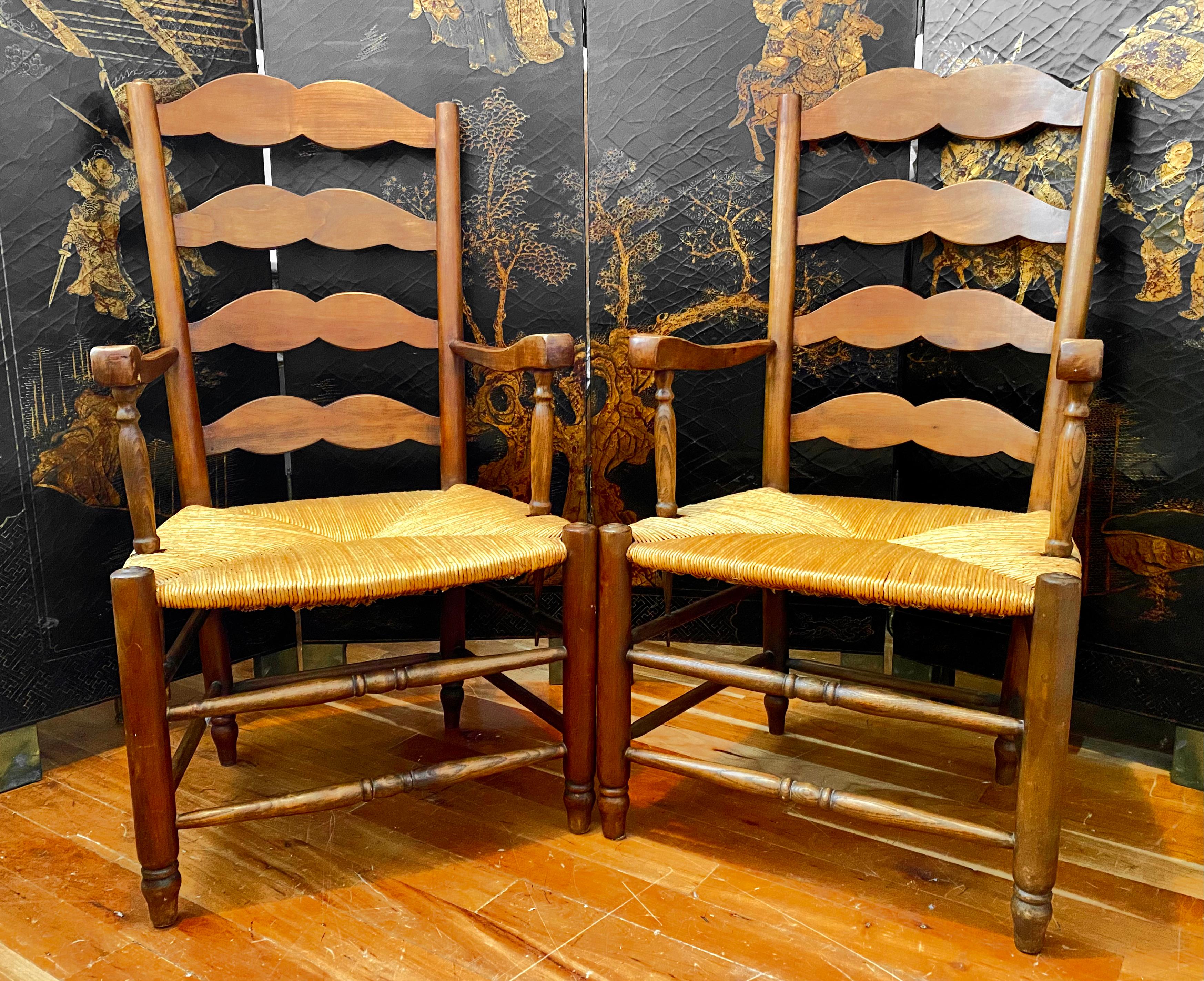 Pair of Provençal ladderback armchairs with rush seating. Classic country armchairs in very good condition, beautiful model with pure lines. These armchairs were used both as table seating and to relax by the fireside as they are sturdy and