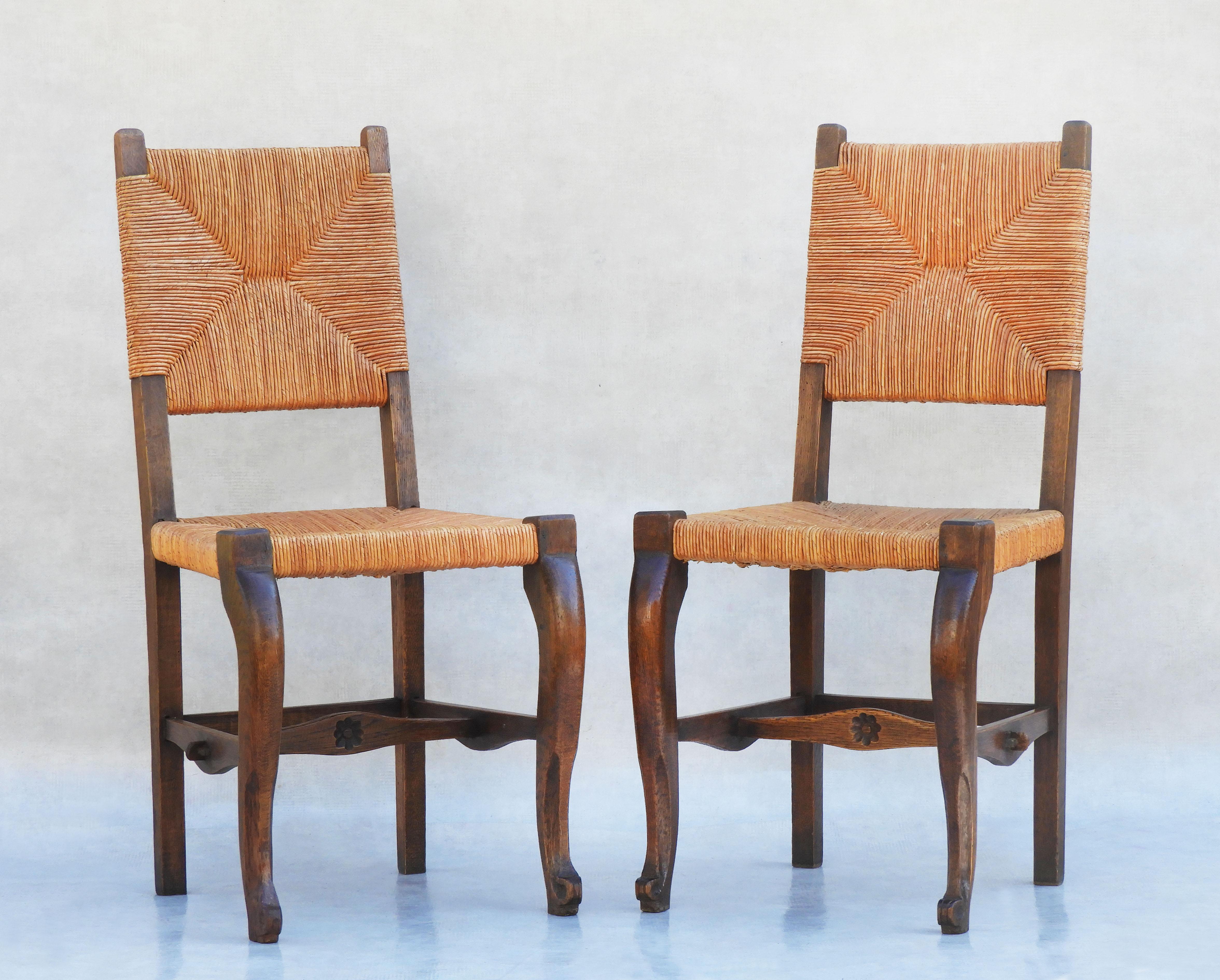 Charming Pair of Provincial French oak and rush back and chairs C1920       
All original carved oak frames, with cabriolet legs, pawed feet, woven rush work backs and seats and daisy emblem detailing. In good antique condition, sound, solid and