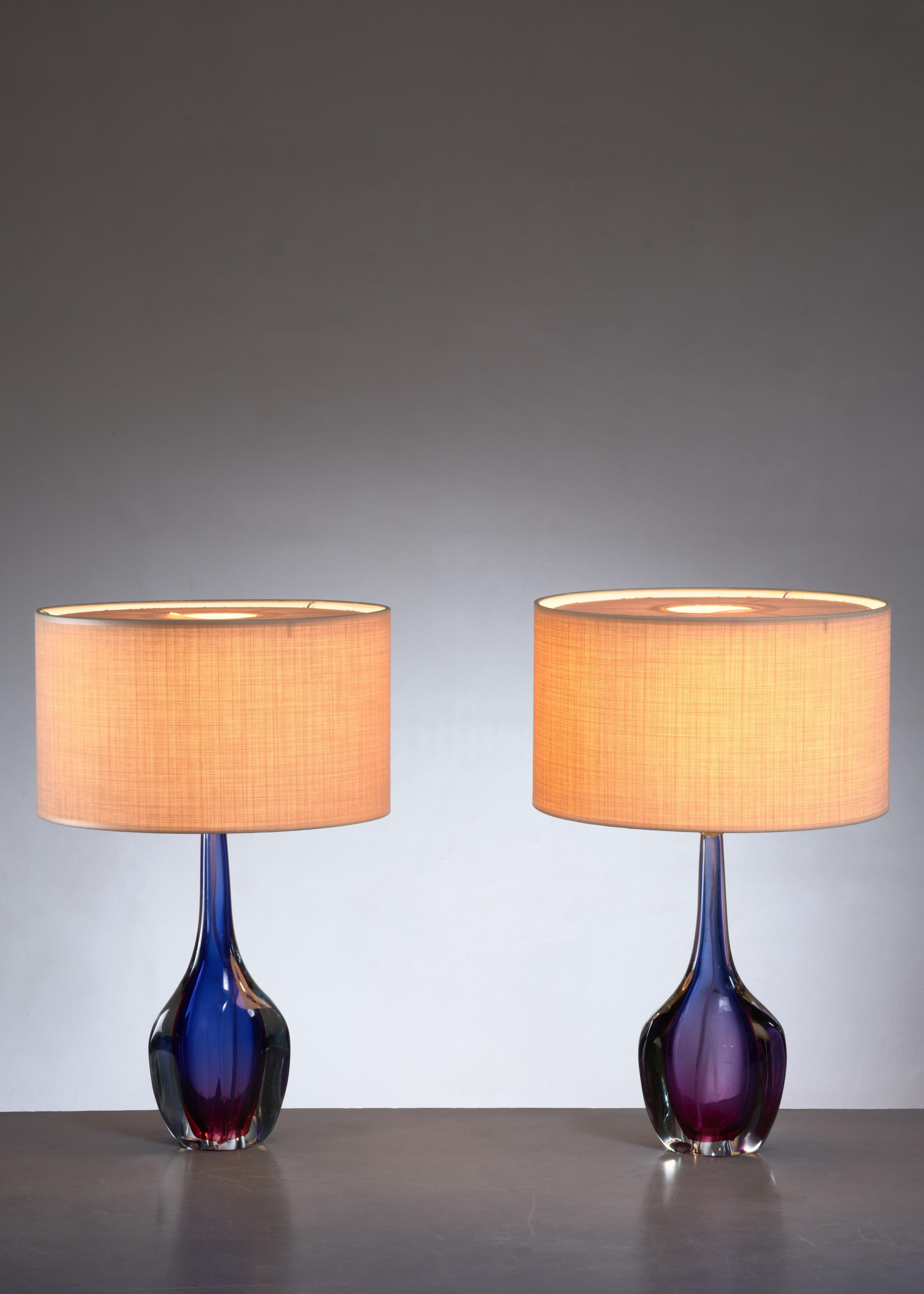 A pair of Murano glass table lamps with a blue and purple pattern in the glass, attributed to Flavio Poli. They are labeled by Arte Nuova, Murano with the text 'Grand Prize - Genuine Venetian Glass - World Fair Brussels 1958'

The measurements