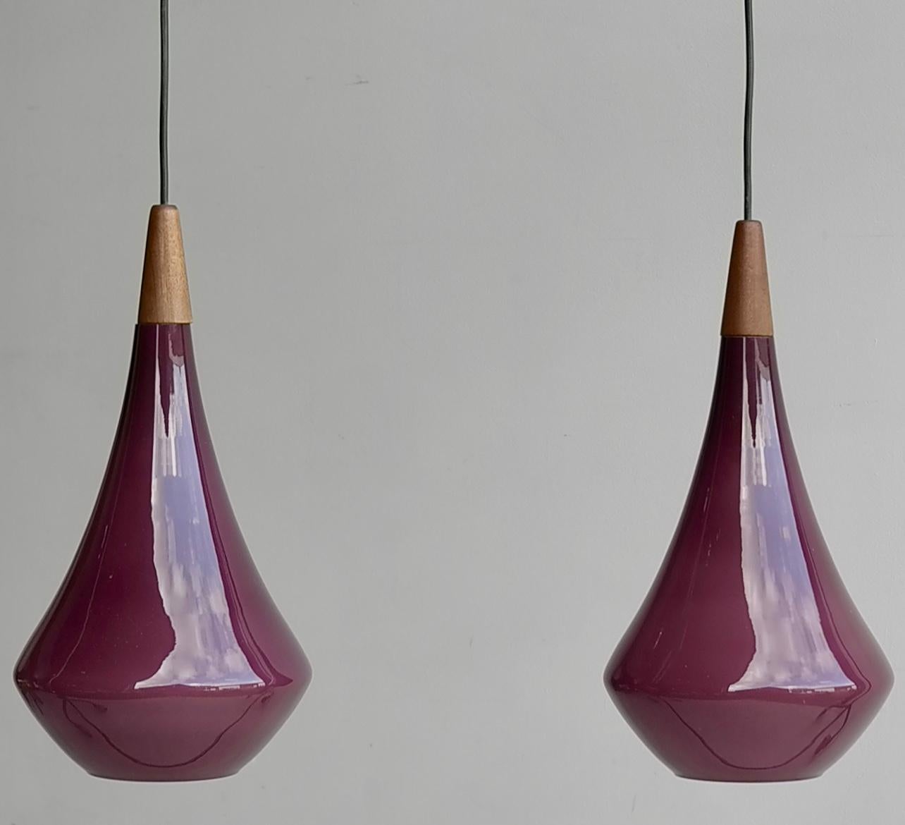 Pair of Purple Glass 'Drop' pendant lamps by Holmegaard Kastrup, Denmark 1960's

All Holmegaard glass is manual made, lovely finished with Teak ends.