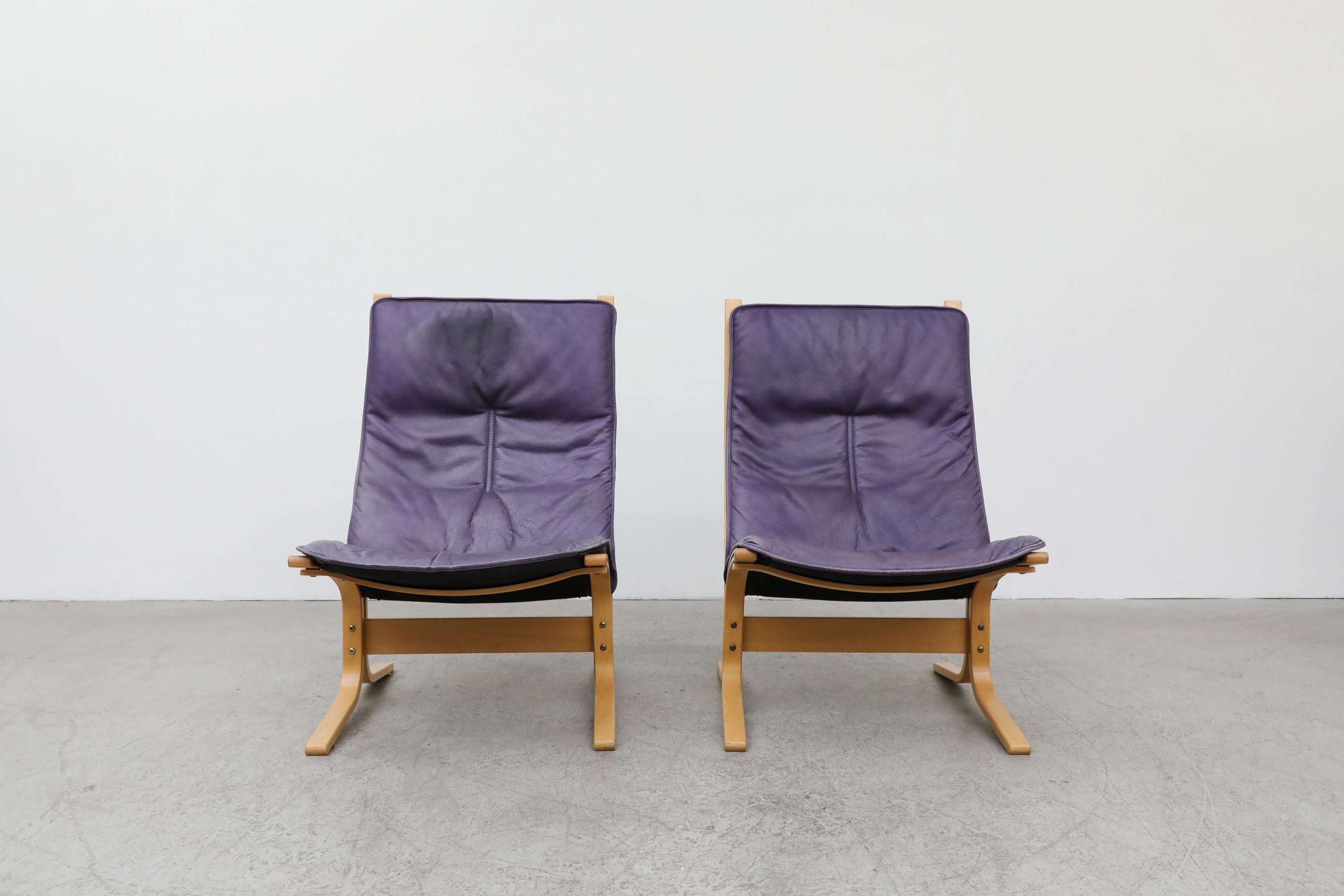 Pair of purple leather westnofa lounge chairs with bentwood frames and original leather cushions. In good original condition with visible wear to leather and frames, including Brill Cream stains on leather. Wear is consistent with their age and use.