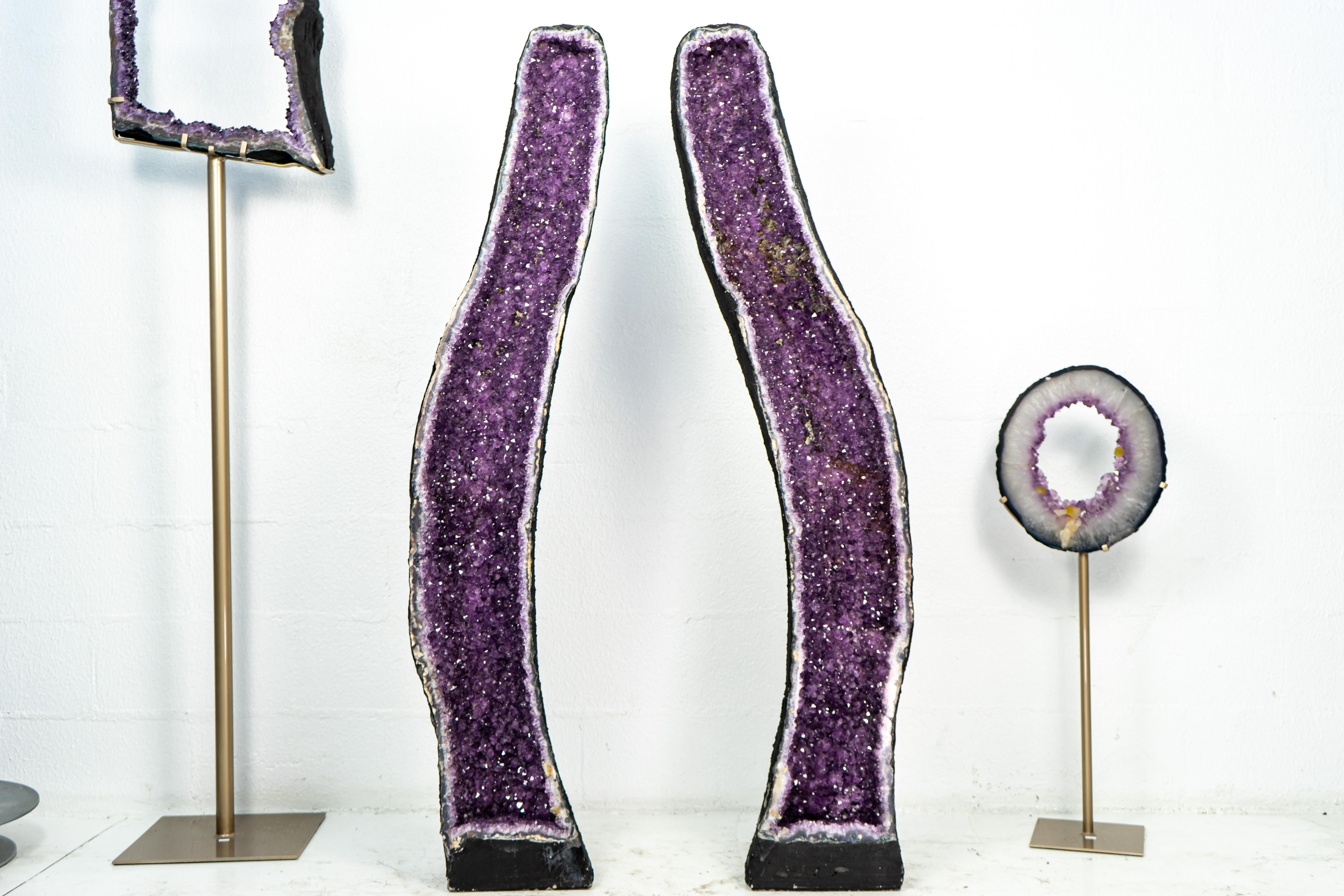 With beautiful aesthetics, tall formation, and naturally shaped on an archway, this pair of bookmatching Amethyst geodes has its origins in the mines of our hometown, Ametista do Sul, and are ready to become the central item of your décor, adding