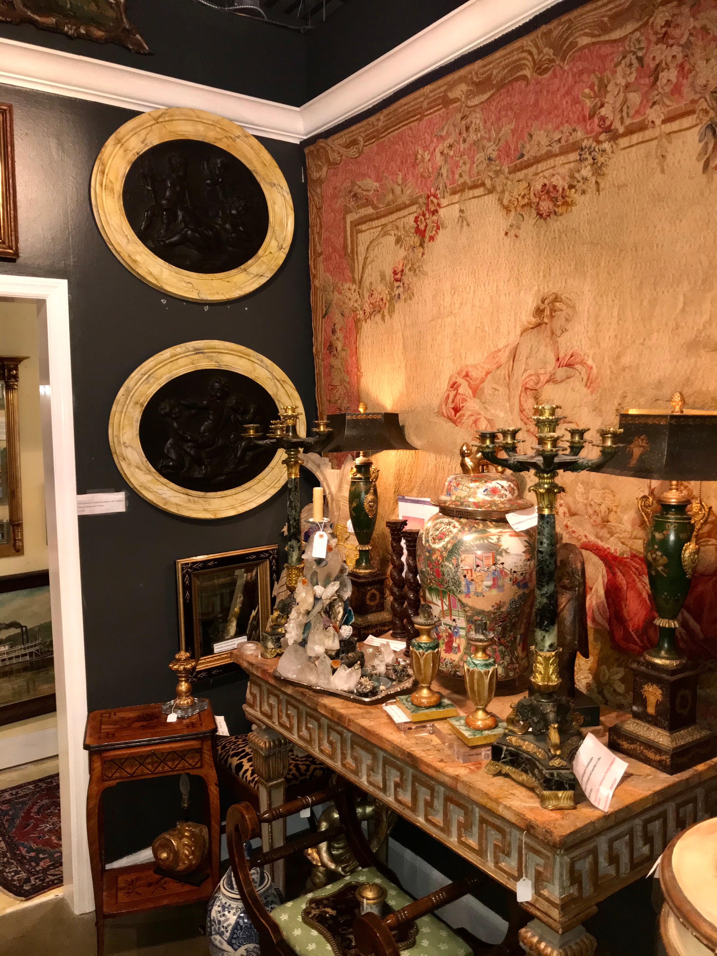 Set of continental composition wall plaques or medallions of frolicking or playful putti / cherubs (children). Faux marble wood frame.

Chips, nicks, wear to frames. The patinated center subjects in very good condition, with light craquelure.
