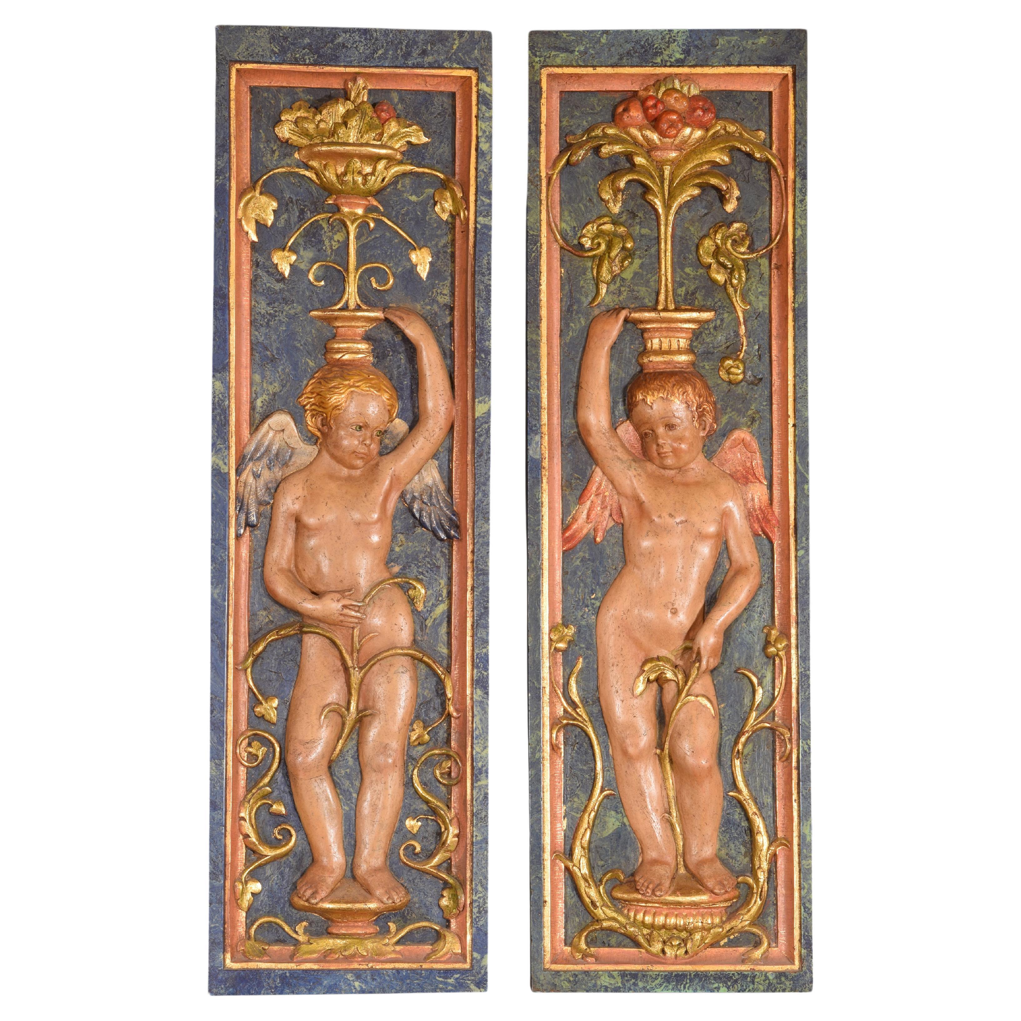 Pair of putti, relief. Molded alabaster. 20th century, after Renaissance models For Sale