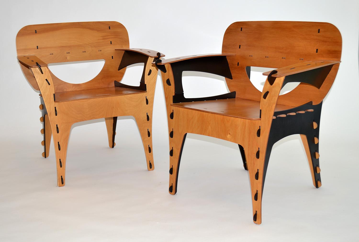 Pair of plywood Puzzle chairs by David Kawecki, 1990's. Armchairs, side chairs or lounge chairs constructed of precision-cut plywood in walnut and ebony finish. Manufactured by 3D Interiors, San Francisco. Labeled.