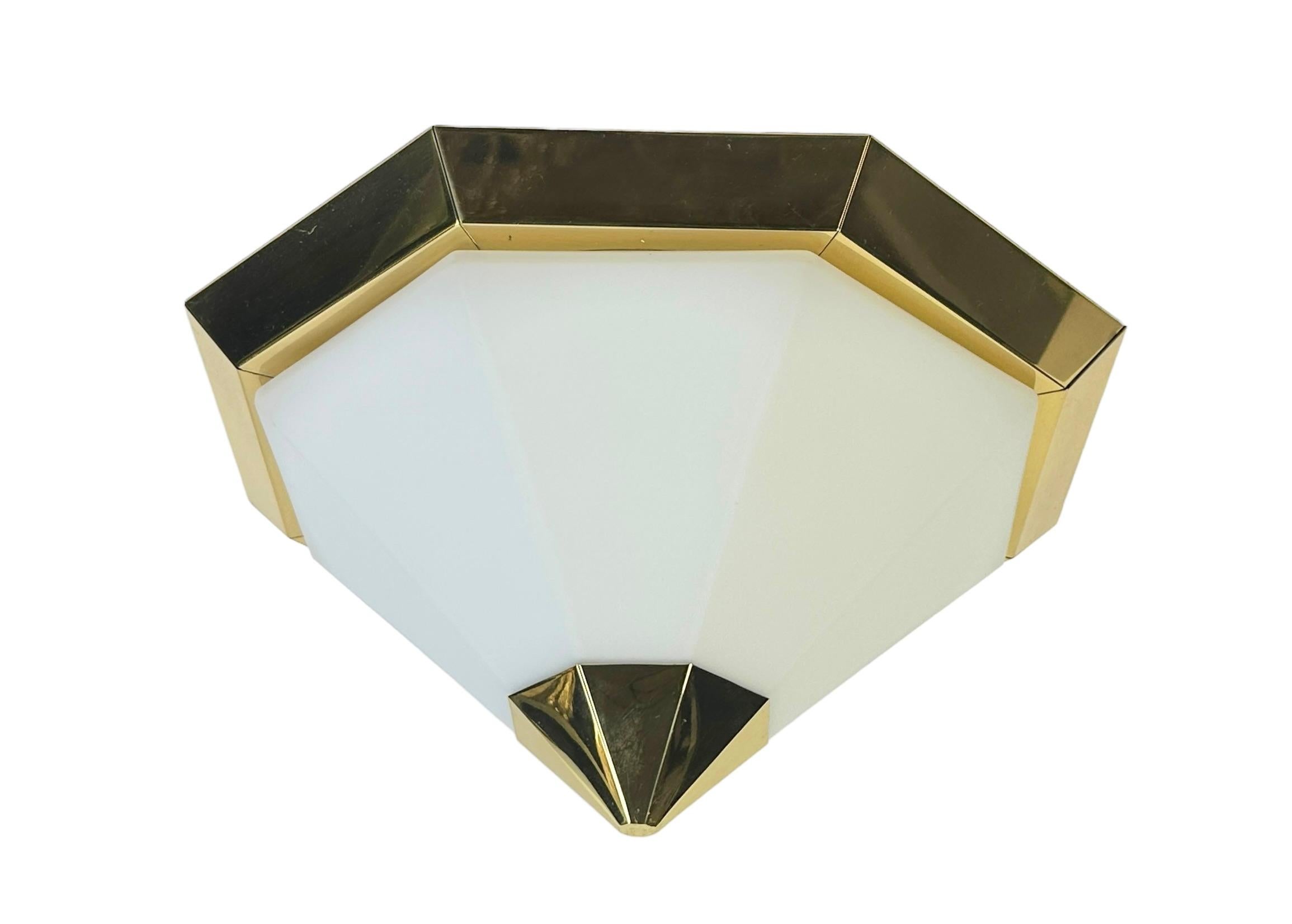Petite pair of pyramid flush mount manufactured by Glashütte Limburg. They have a beautiful cone shape and are made of solid brass and opaline glass. The inside is made of metal. Each Fixture requires one European E27 / 110 Volt Edison bulb, each