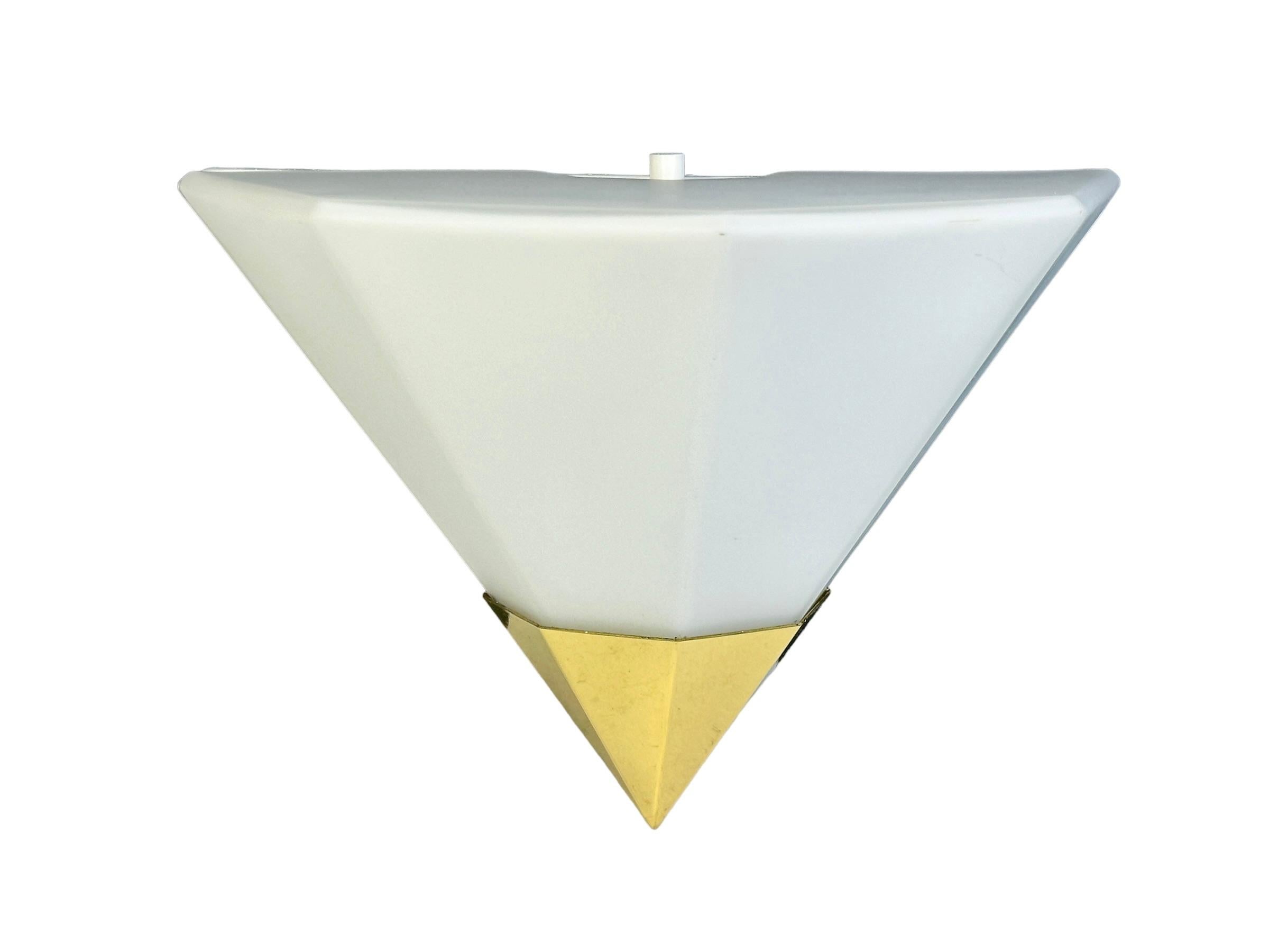 Petite pair of pyramid sconces manufactured by Glashütte Limburg. They have a beautiful cone shape and are made of solid brass and opaline glass. The inside is made of metal. Each Fixture requires one European E27 / 110 Volt Edison bulb, each bulb