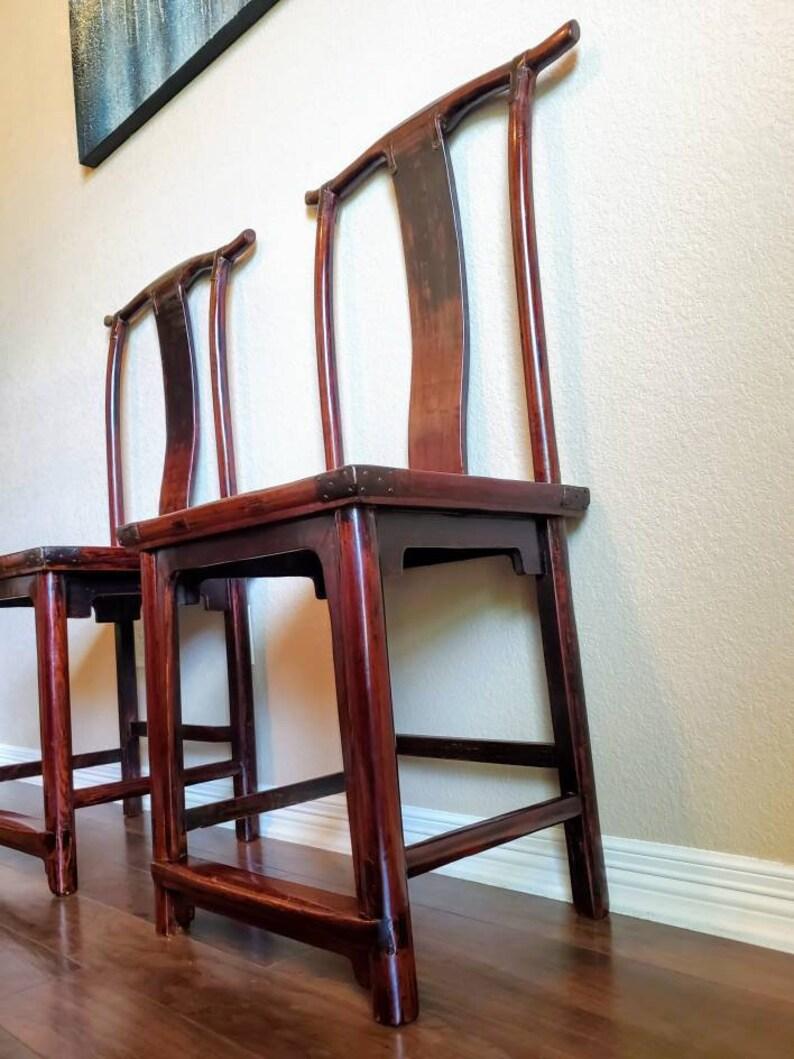 A Qing Dynasty pair of high back officials hat chairs from Shanxi, China, exquisitely handcrafted in the 19th century. Though made during the Qing Dynasty (1644 - 1912), the design of the chairs dates to the Ming Dynasty (1368 -1644). Rattan seat,