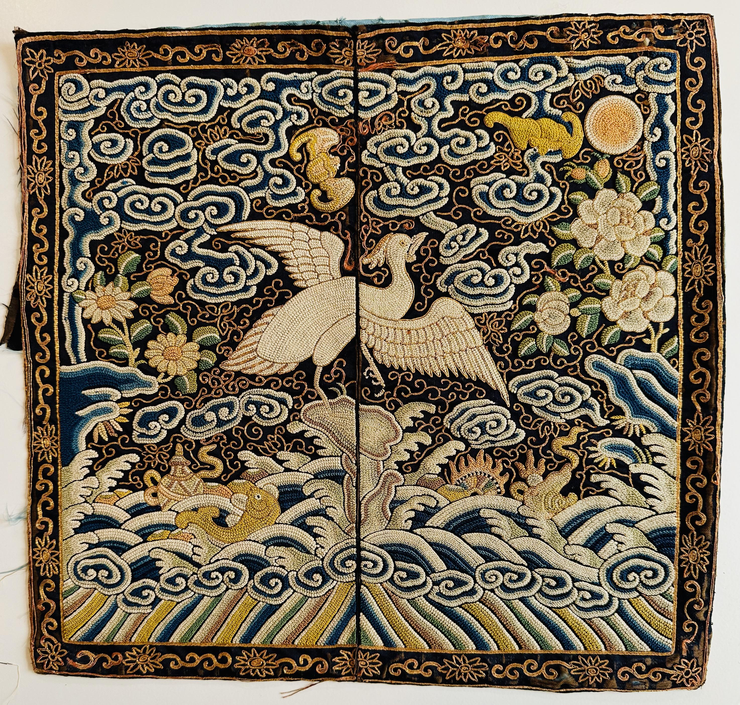Lovely pair of 19th century civil rank badges (buzi) decorated with an egret, denoting a civil servant of the Sixth Rank. The badges are worked in Peking knot and couched gold threads on a dark blue background, with colors of soft green, blues and