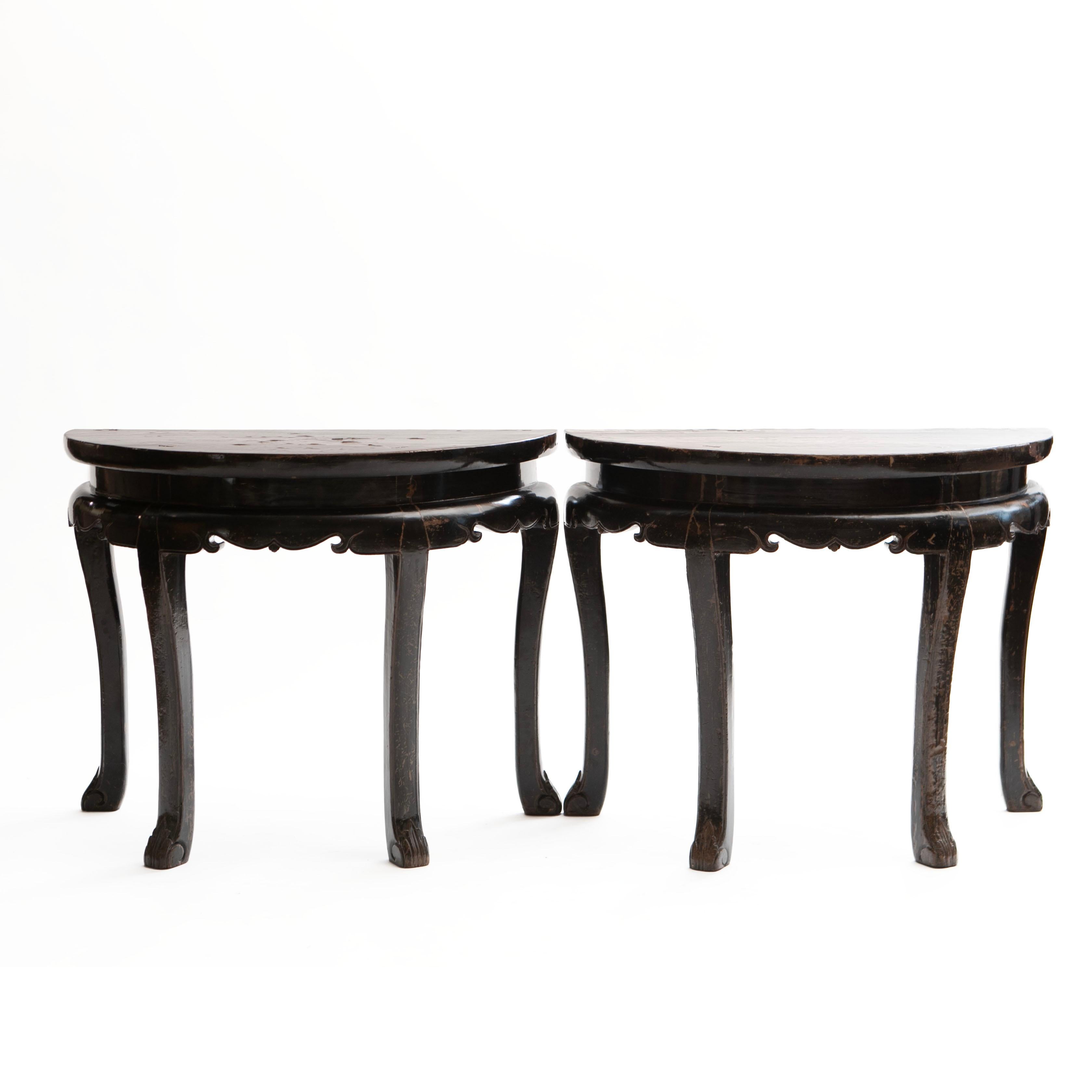 Center Table ore A pair of decorative half-round console tables, also known as Demilune tables.
These tables can be used individually or combined as a circular center table if placed together. 
Crafted in walnut with black lacquer and natural