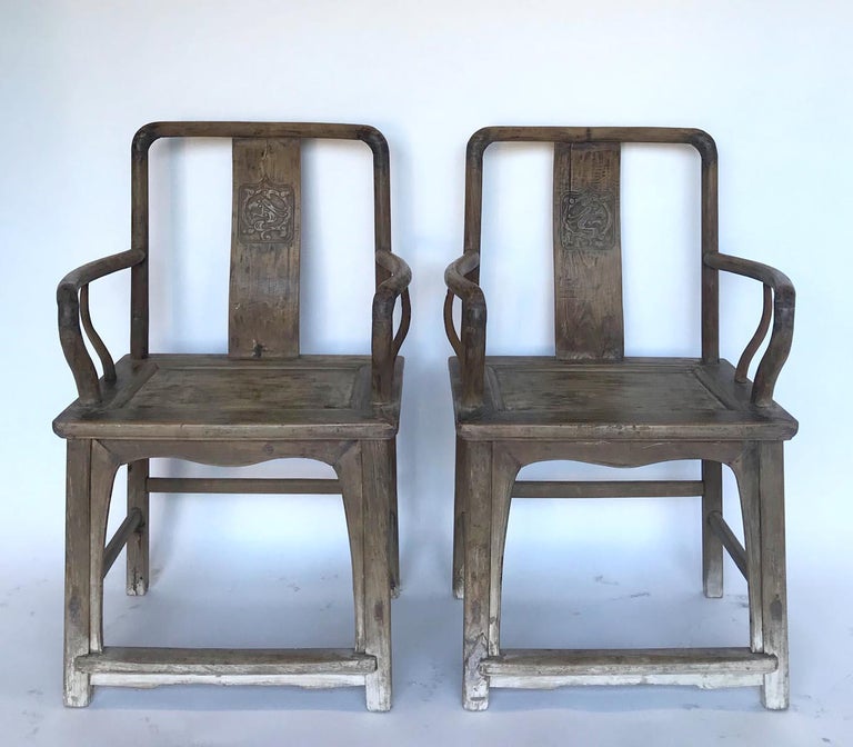 Chinese Qing dynasty chairs in light Elm. Mid 19th century construction featuring mortise and tenon joinery and wooden nails. Elegant craftsmanship the detail of the detail of curved arms. All parts of the chairs are smooth and have a natural