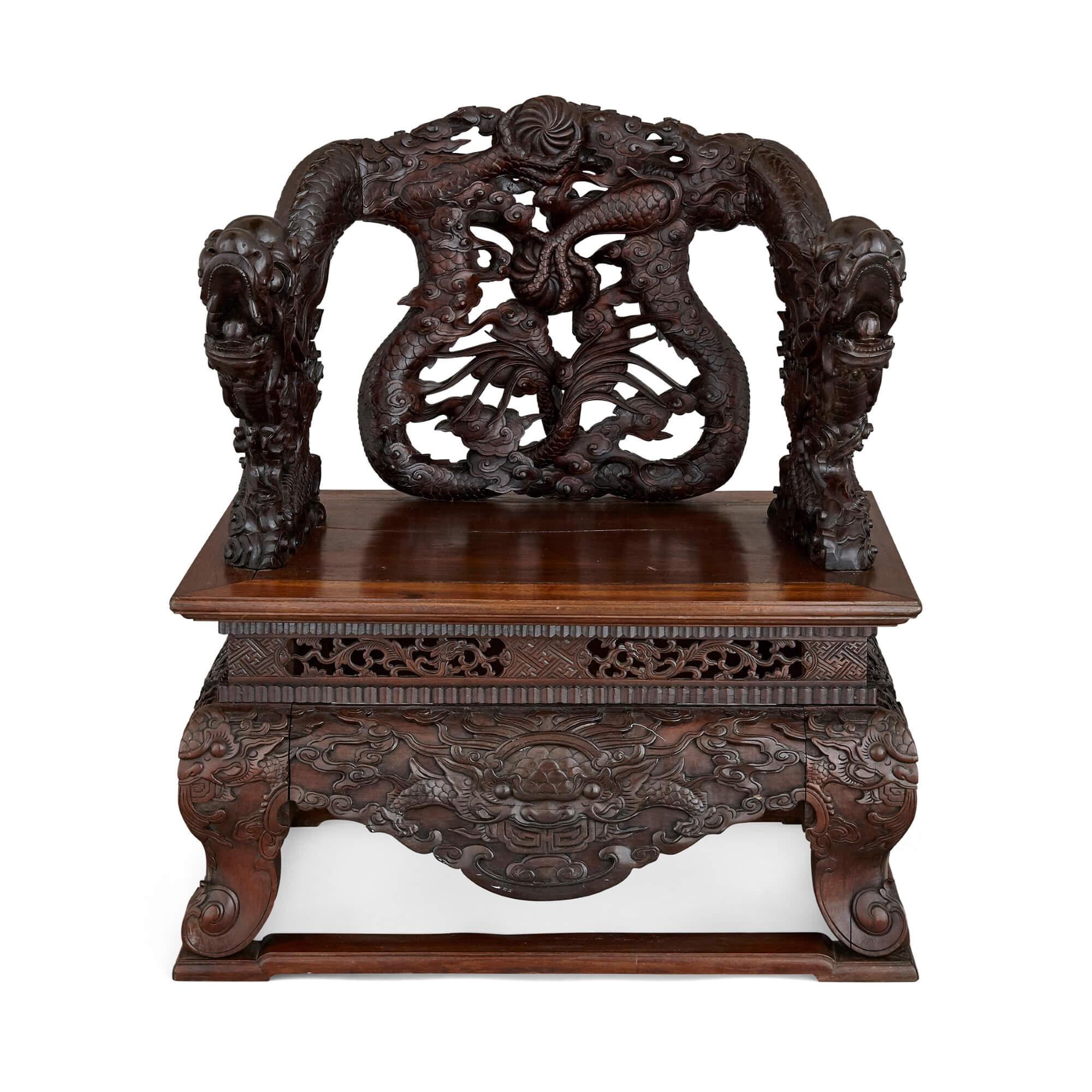 This pair of carved Chinese hongmu or rosewood armchairs date from the late Qing Dynasty, and combine extravagance and opulence with style and refinement. They are adorned with mythological motifs, typical of this period, the major decoration here