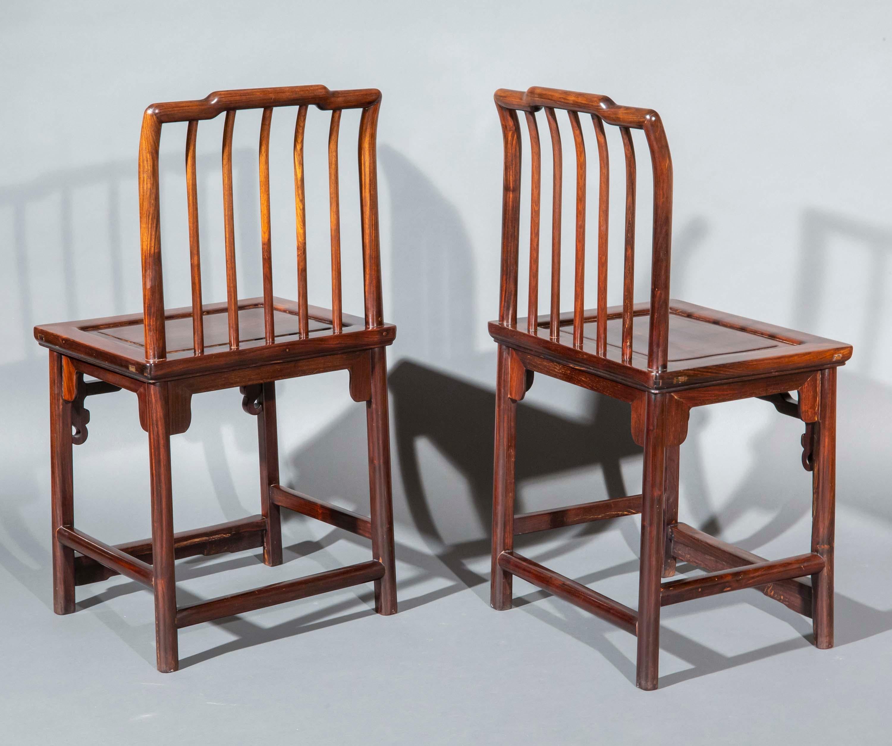 A stunning pair of Chinese Ming style side chairs or meiguiyi, with spindle-backs and solid seats.
China, Qing dynasty, circa 1800–1900.

Why we like them
Their smart design, superb quality and richly patinated, original colour make these chairs a
