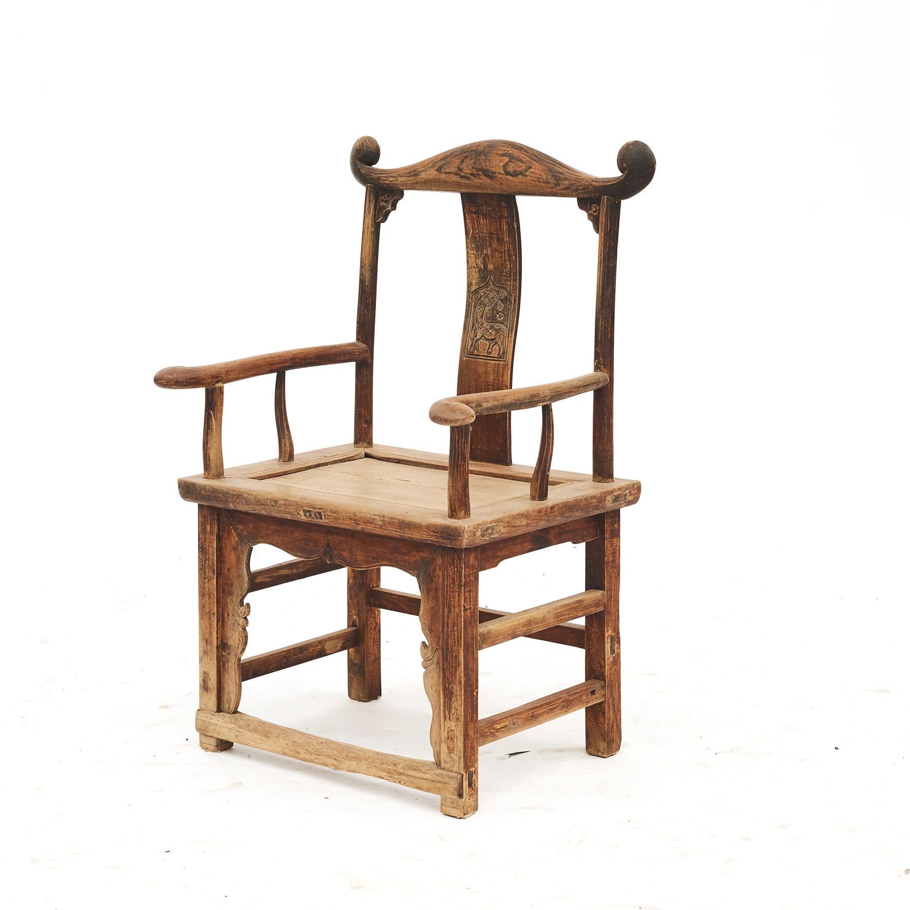 A pair of Chinese official's hat armchairs from the early 19th century. Also referred to as Yoke back chairs.
From Shanxi, China and dates to the early 19th century.
Elmwood with a beautifully aged patina. Carvings of a horse on the