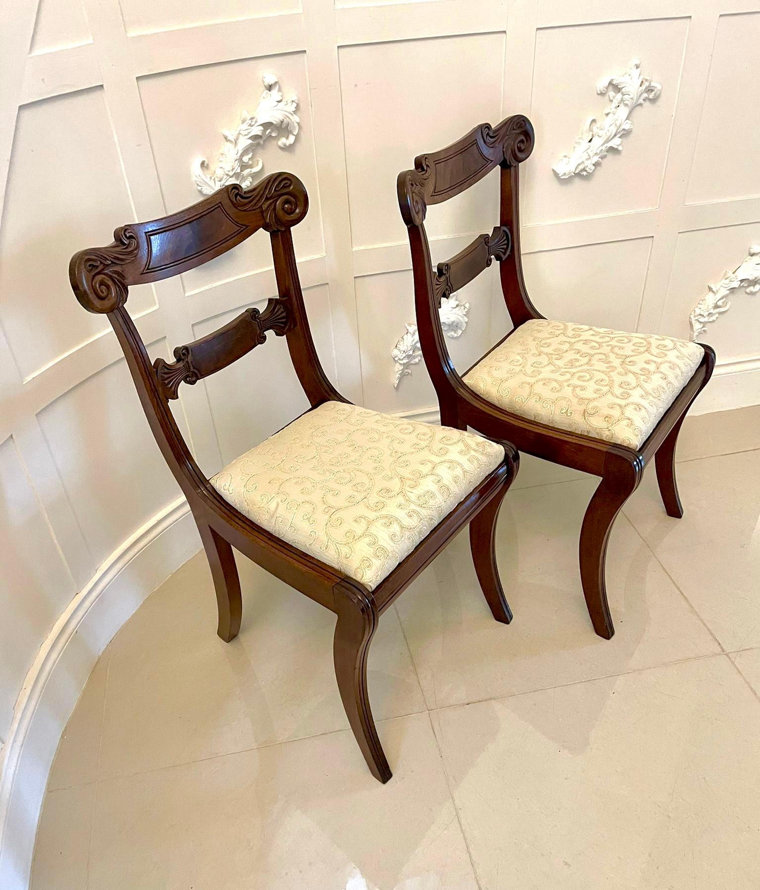 Pair of quality antique Regency carved mahogany side chairs having a quality shaped carved mahogany top rail and centre splat, newly reupholstered drop in seats in a quality fabric and standing on elegant shaped reeded sabre legs to the front and