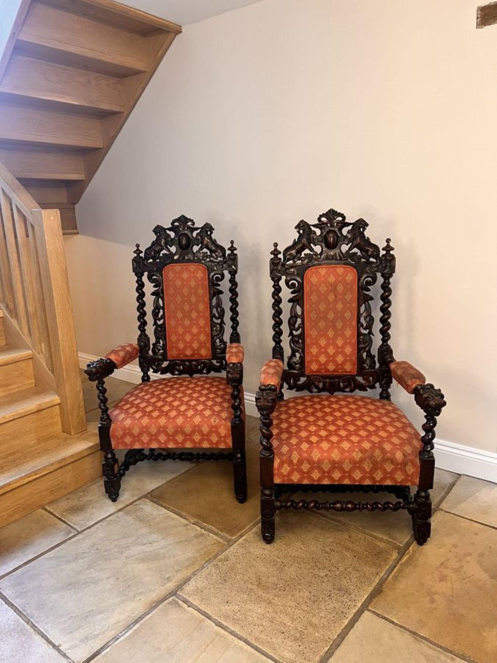 Pair of quality carved oak antique Victorian throne chairs, having quality carved oak backs with carved lions to the top, barley twist supports, carved scrolls upholstered panel backs and seats standing on turned carved legs to the front and barley