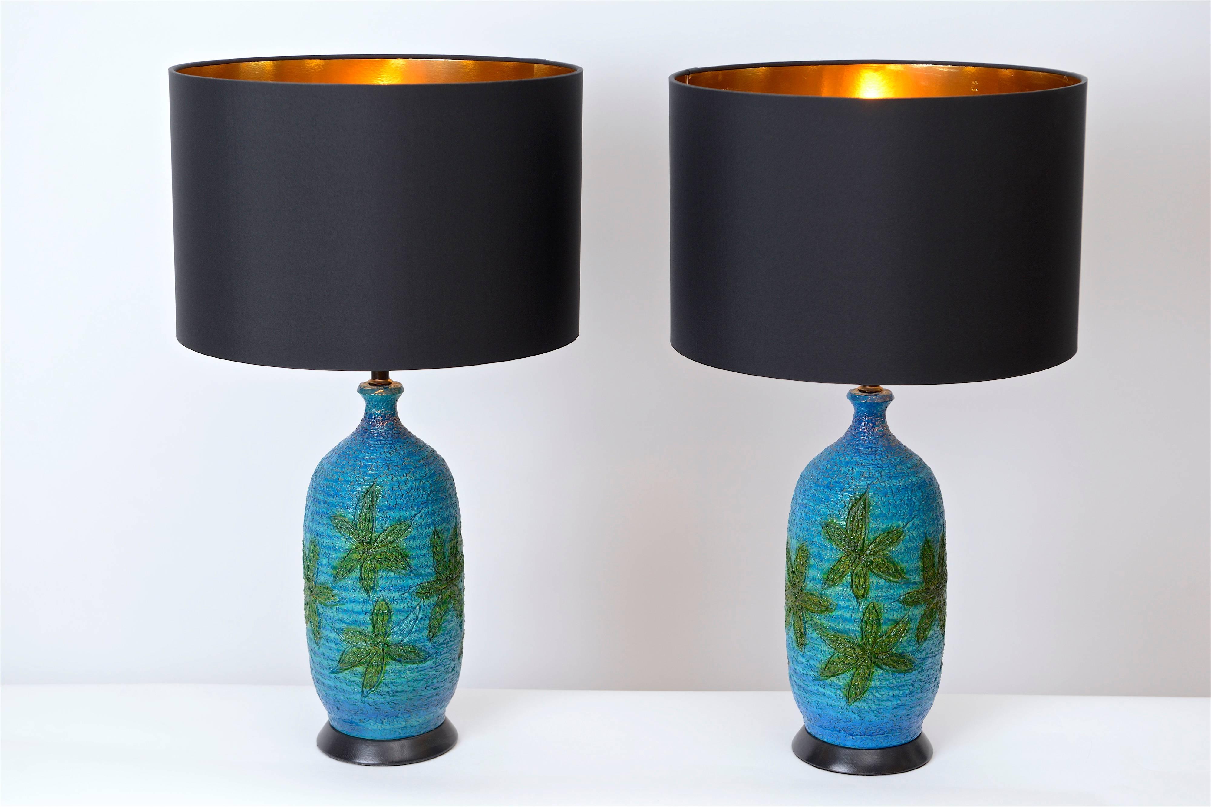 Produced by the New York based company, Quartite Creative Corp., these lamps feature hand-painted, green leaf images on a textured and vivid blue coloured background. Similar to the Bitossi production in Italy, these lamps have a great vintage feel
